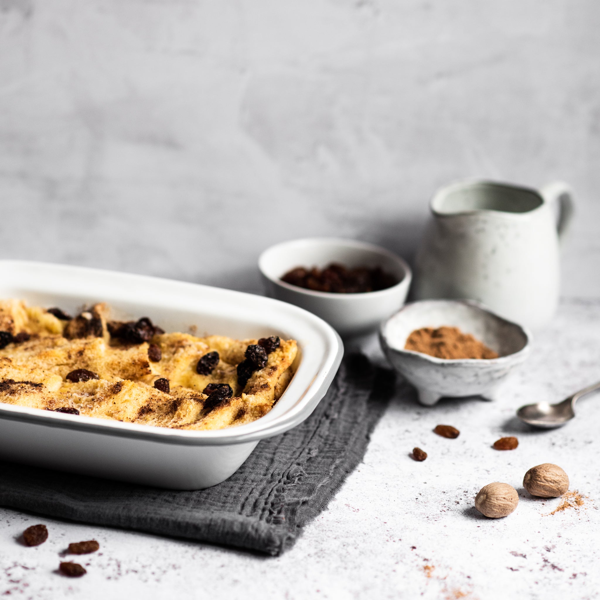 Bread and butter pudding in a tin with raisins