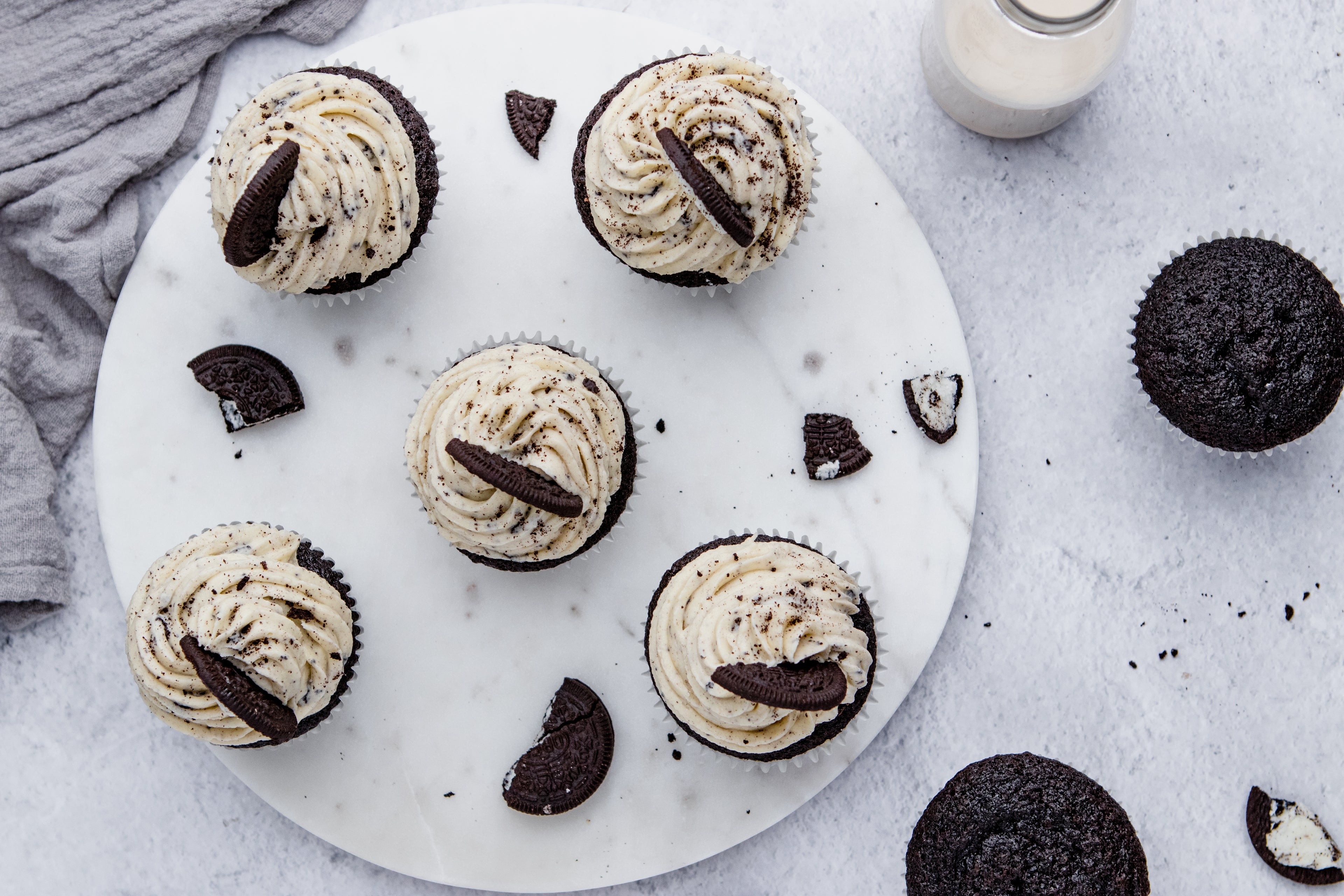 Above view of Oreo Cupcakes on a marble tray, with oreo cookies and crumbs 
