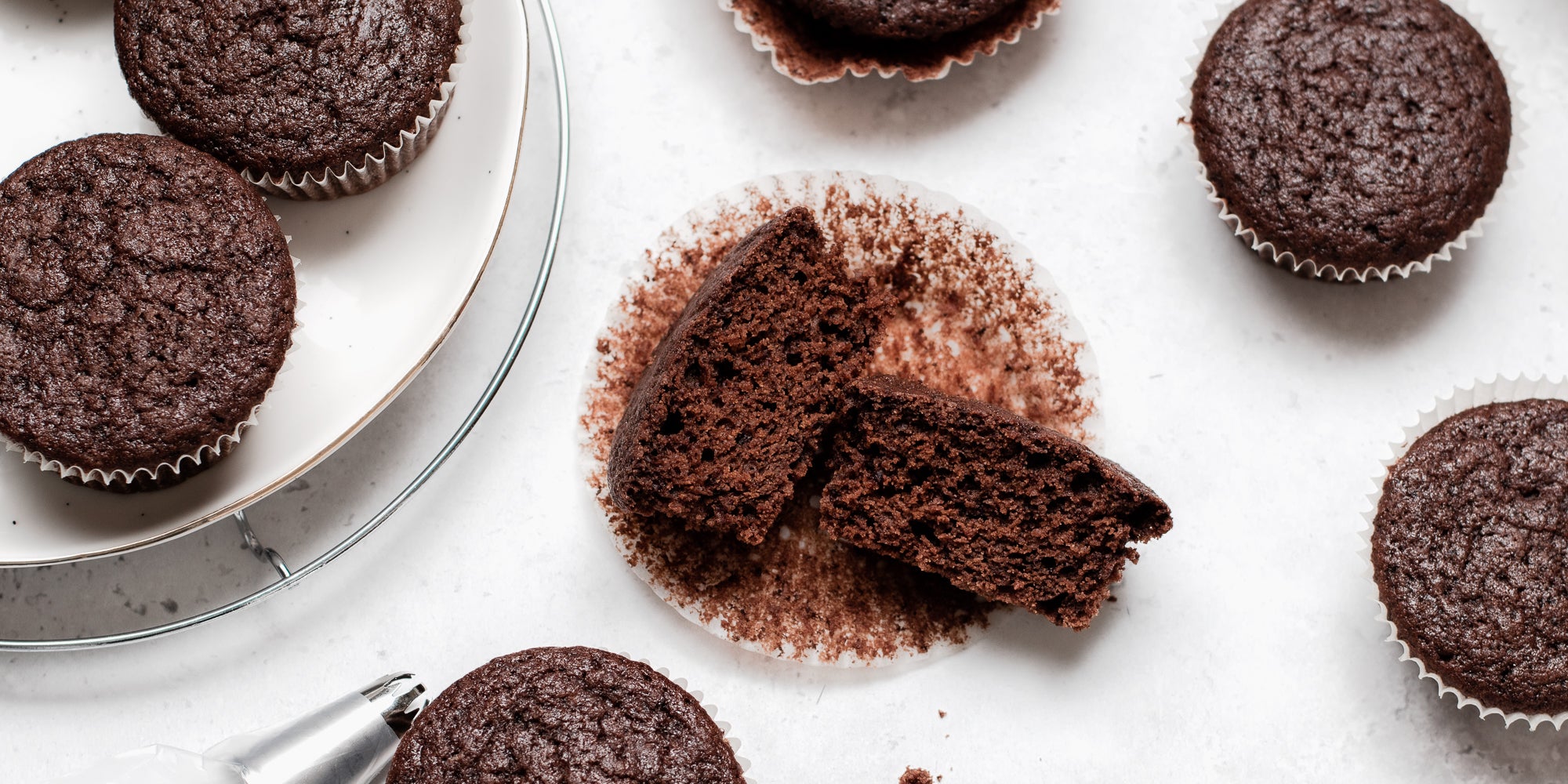 Top view of Vegan Chocolate Cupcakes, with a cupcake cut in half.