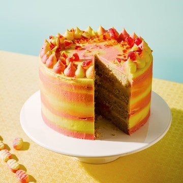 rhubarb and custard cake on a cake stand