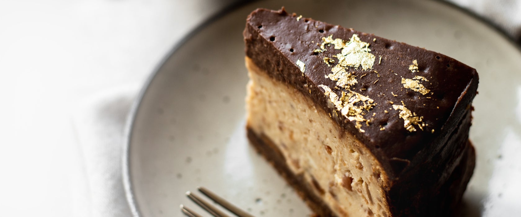 Slice of homemade peanut butter and chocolate baked cheesecake