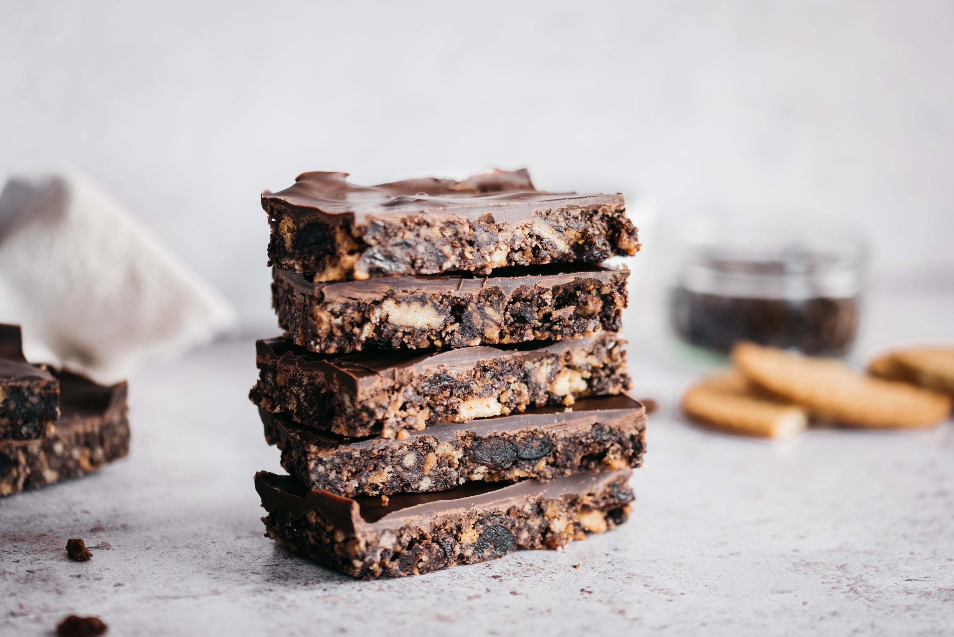 Squares of chocolate tiffin on a grey background