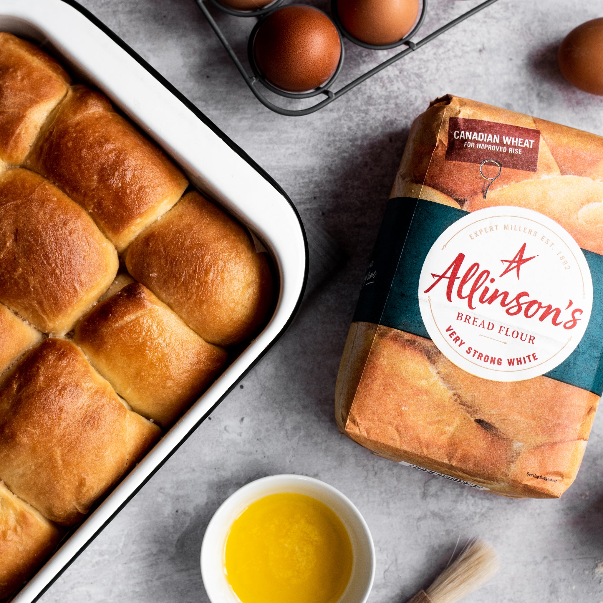 bread rolls in a tin with a side of melted butter and Allinson's bread flour