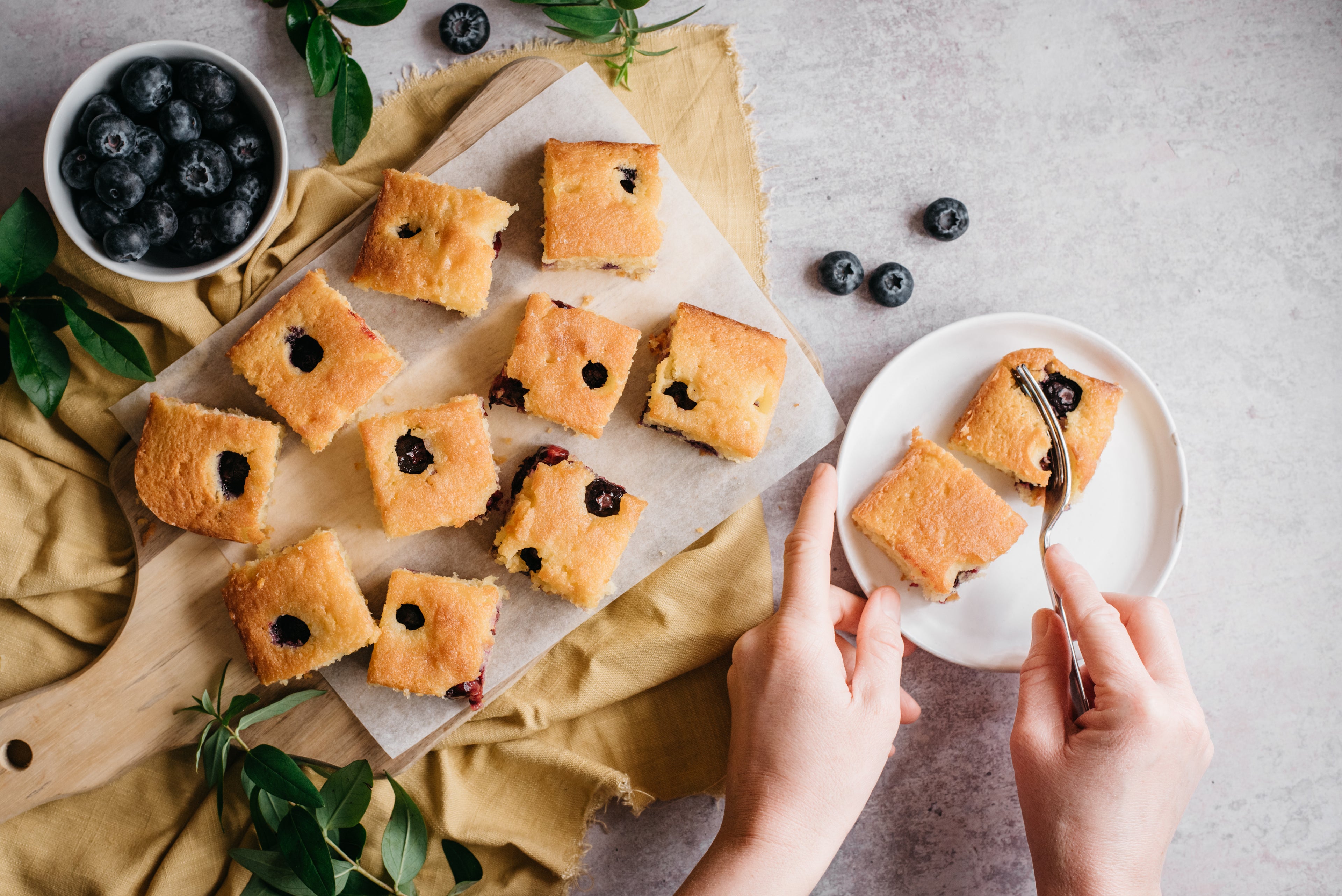 Top down view of low sugar lemon and blueberry traybake