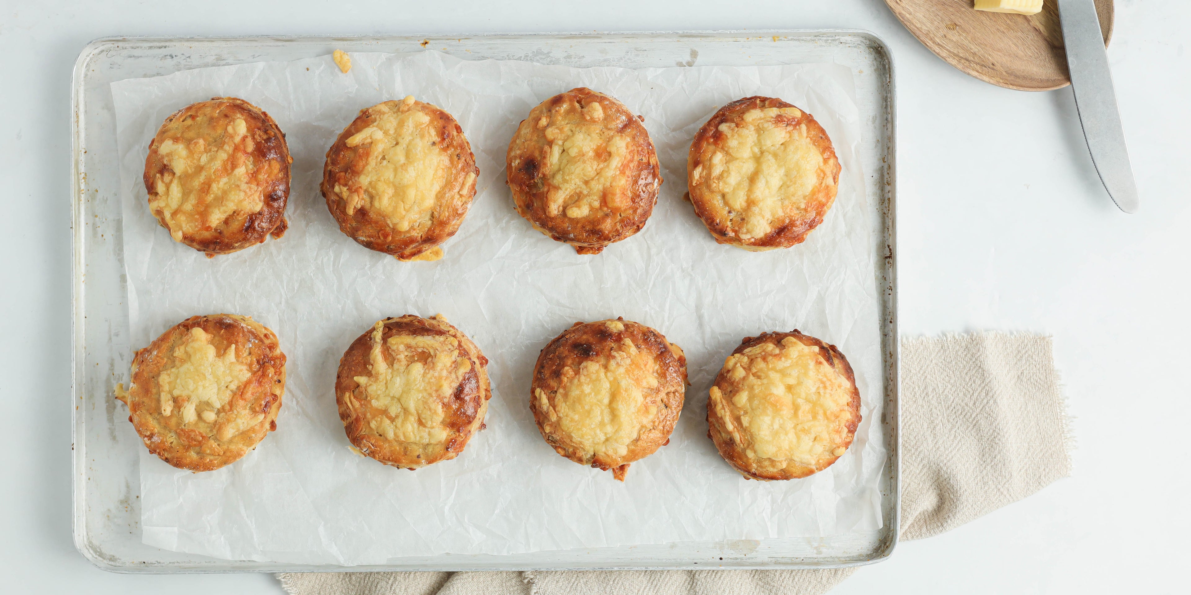 Top view of Cheese Scones on baking parchment on a baking tray