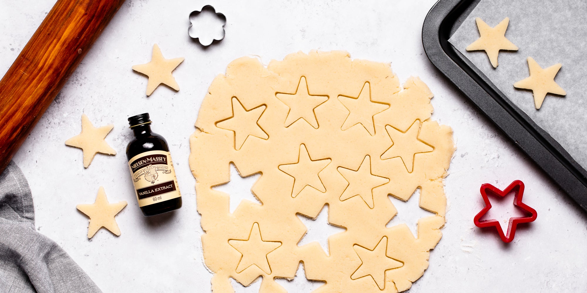 Top down view of cookie cutter stars in vegan biscuit dough