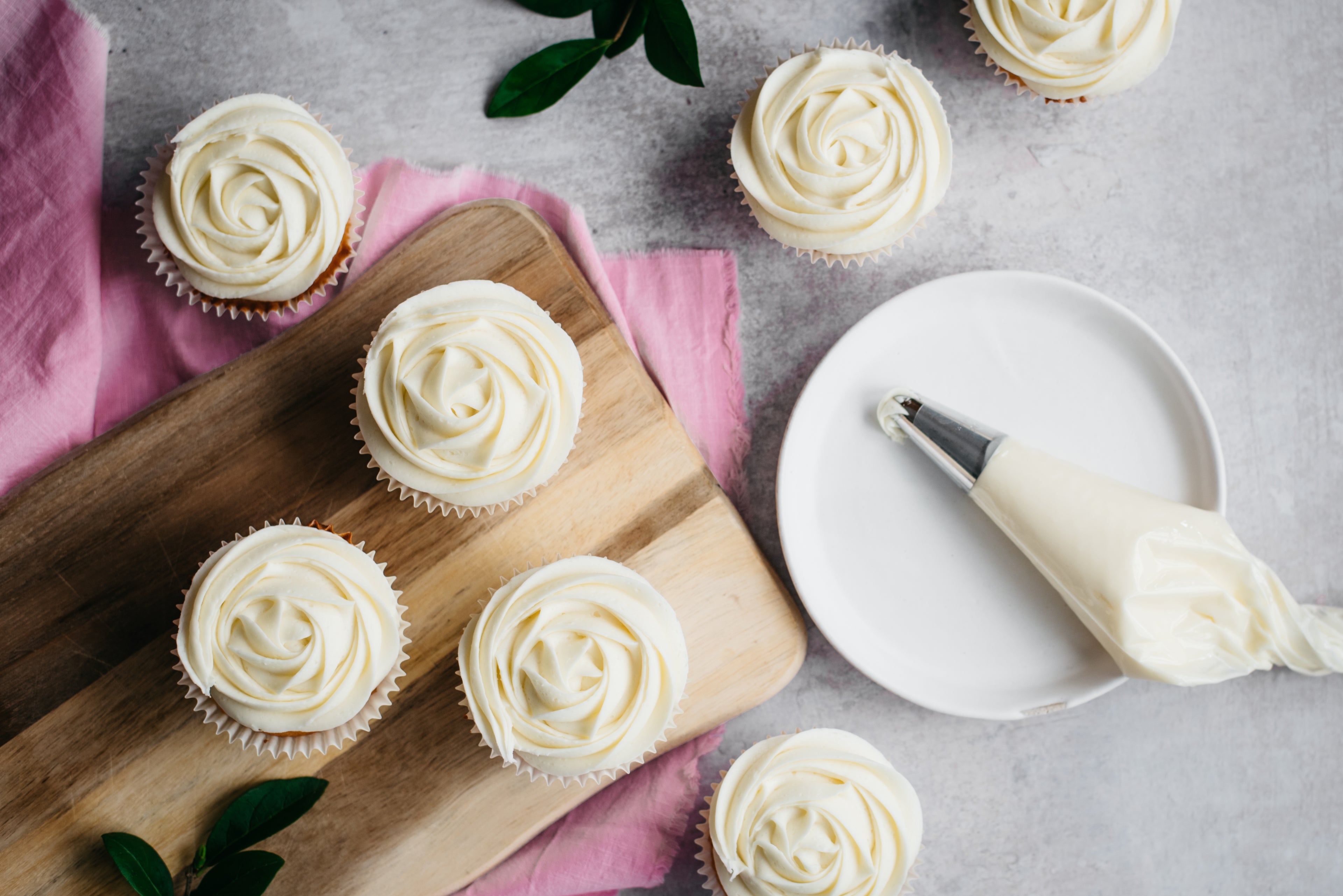 Top down view of cupcakes covered in low sugar cream cheese frosting