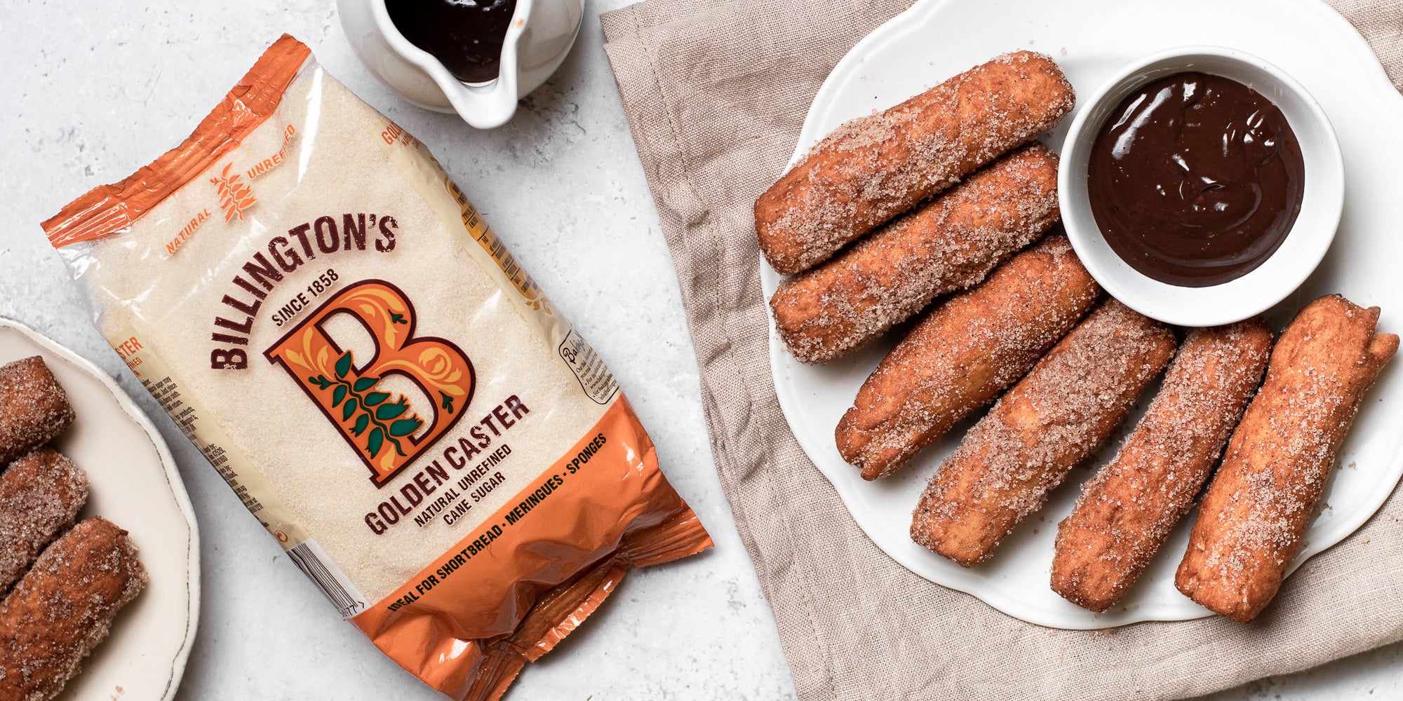 Doughnut Sticks with Chocolate Dip next to a bag of Billington's Golden Caster sugar