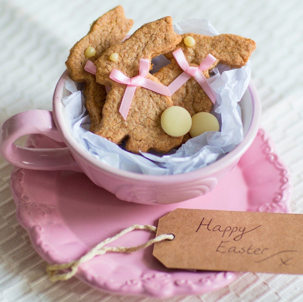 Easter bunny biscuits arranged in a pink teacup