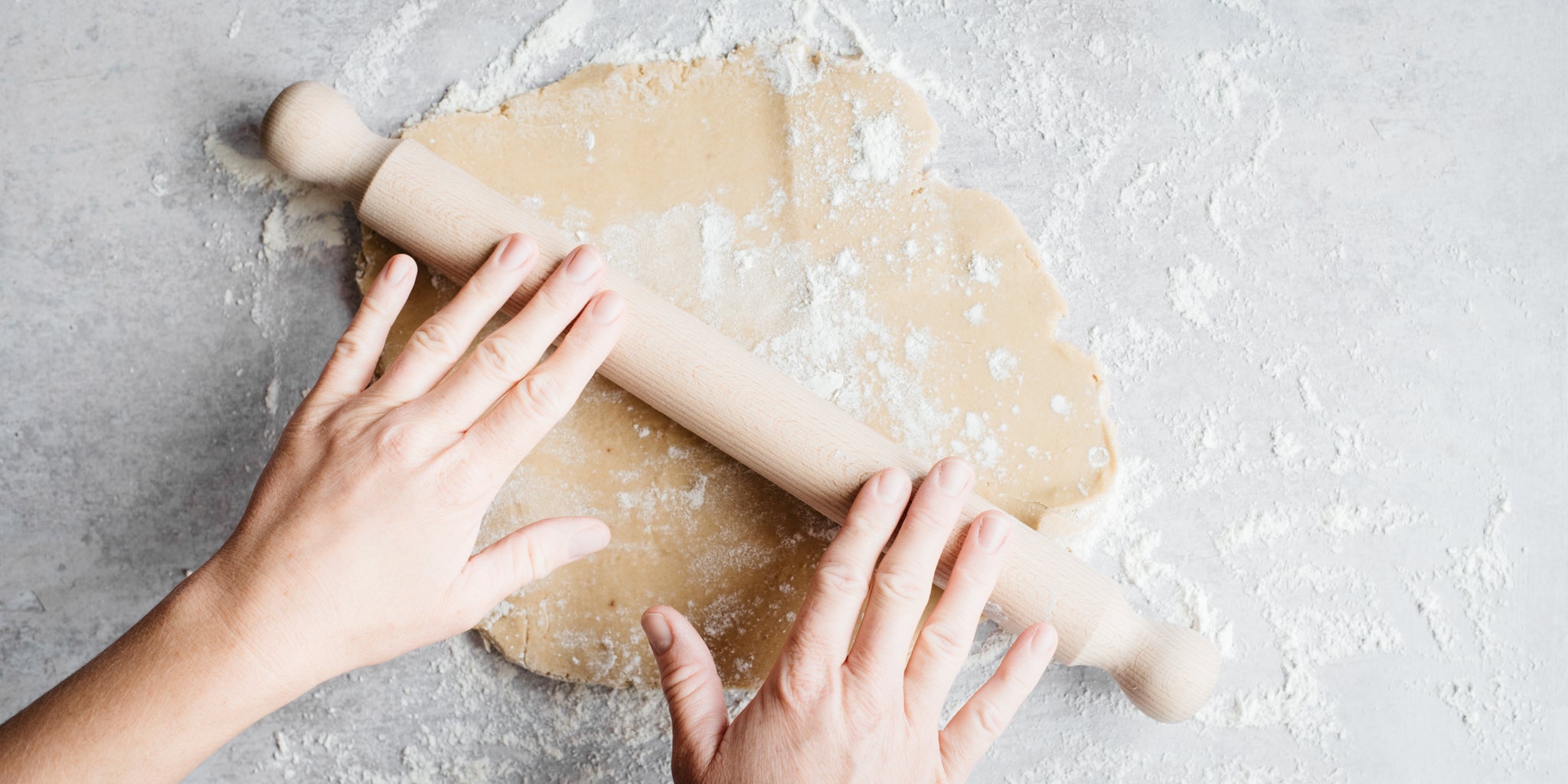 Handing rolling out pastry with rolling pin