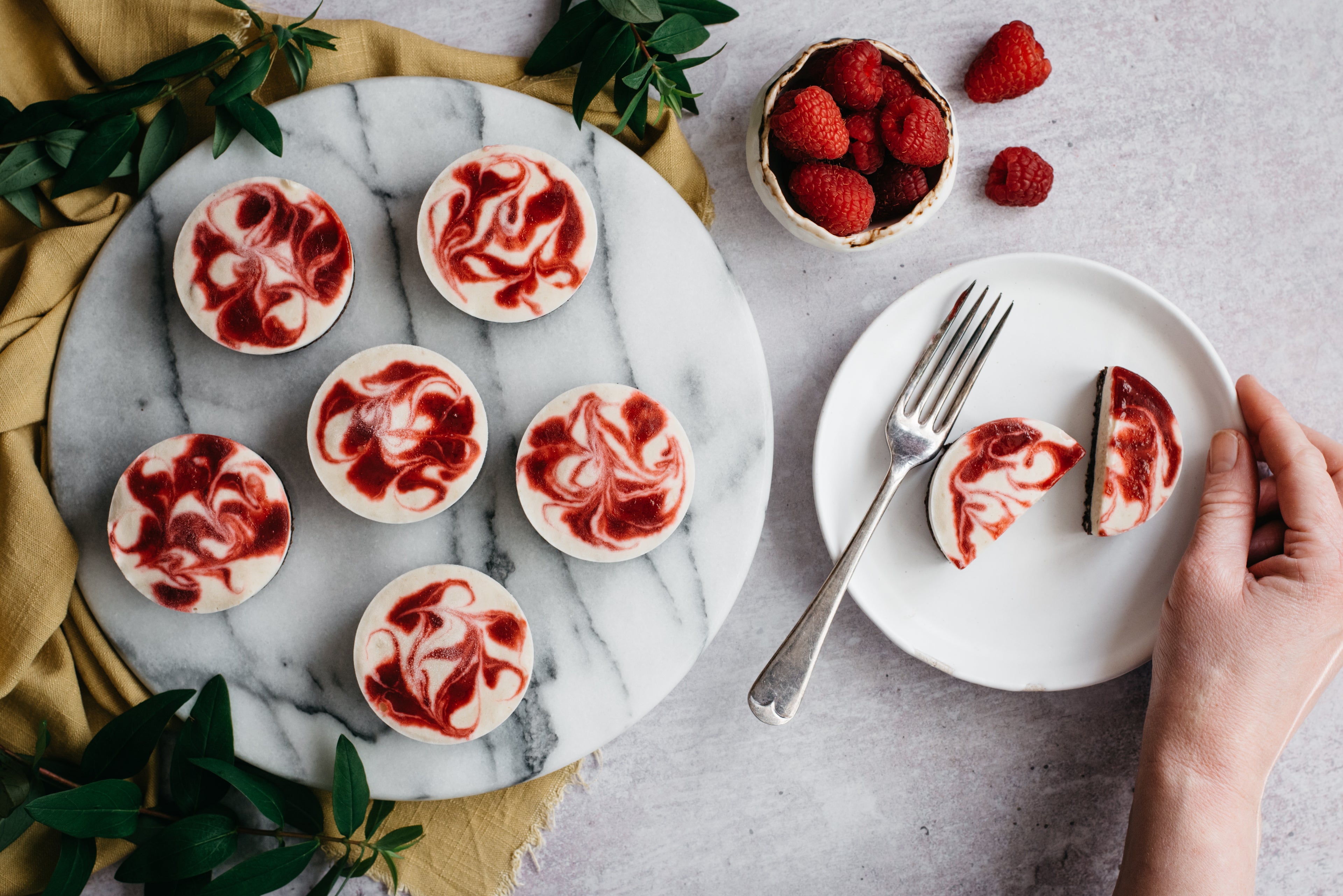 Top down view of a plate of vegan cheesecake cups