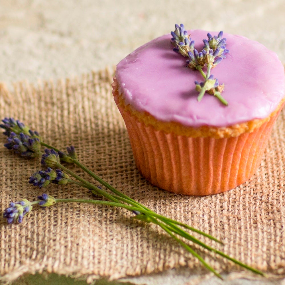 Lavender cupcake topped with pink icing and a sprig of fresh lavender