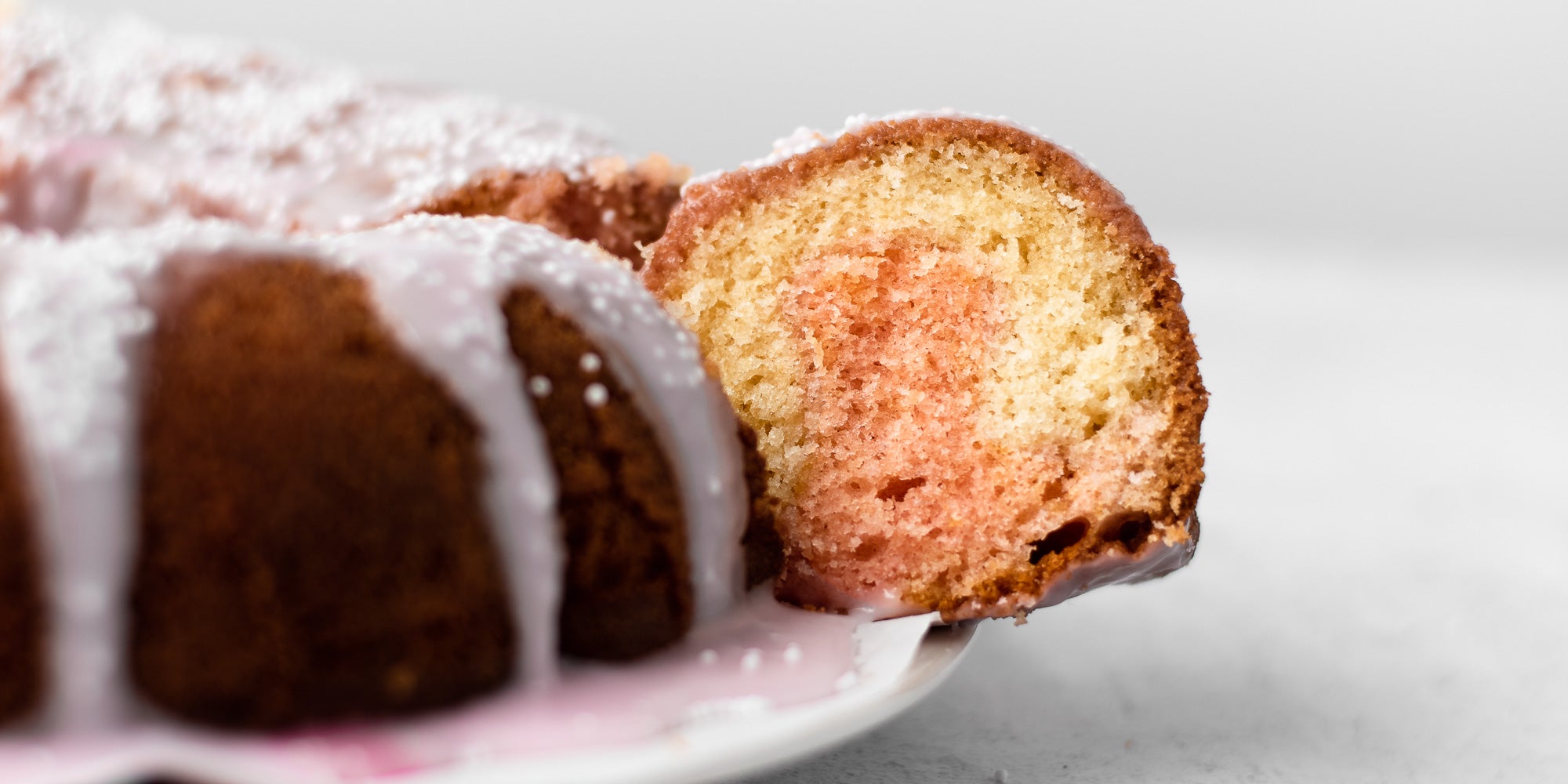 Strawberry Marble Bundt Cake with a slice taken out