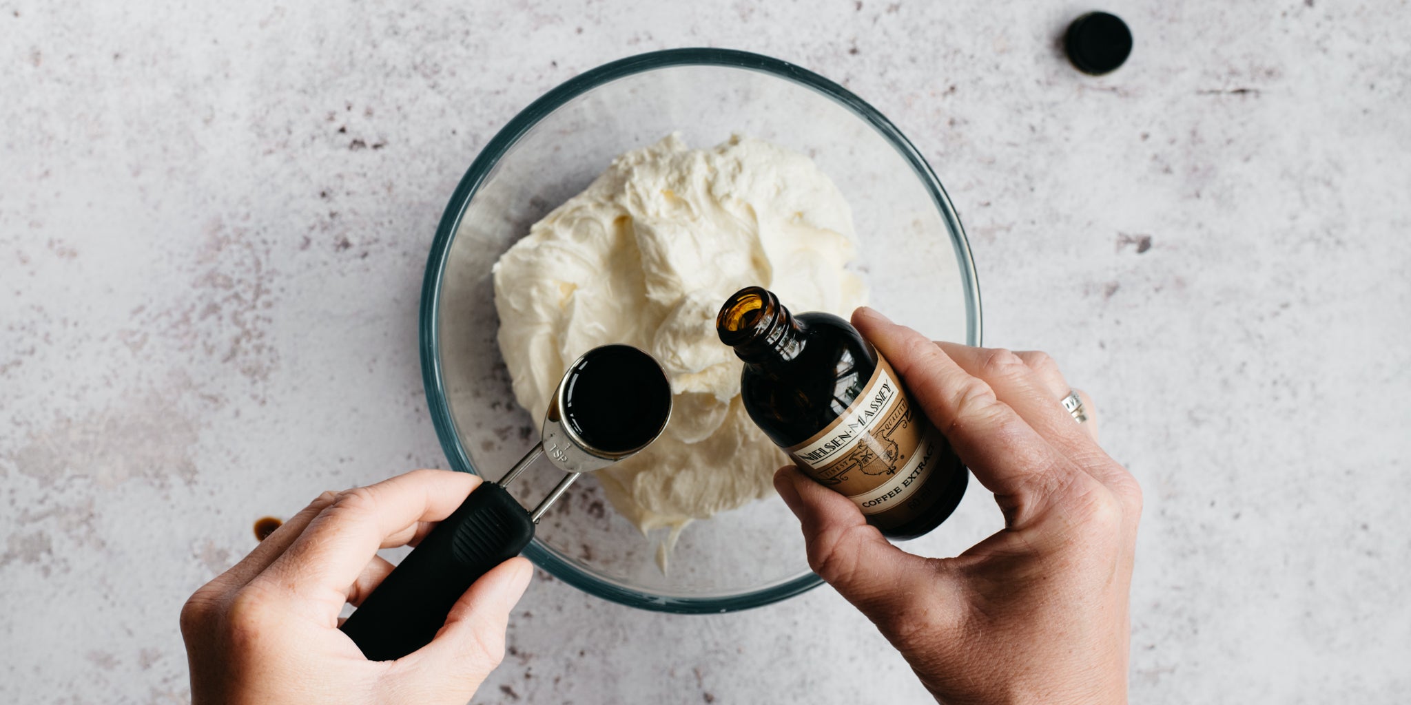 Coffee buttercream being whipped with a serving of Nielsen-Massey Coffee extract