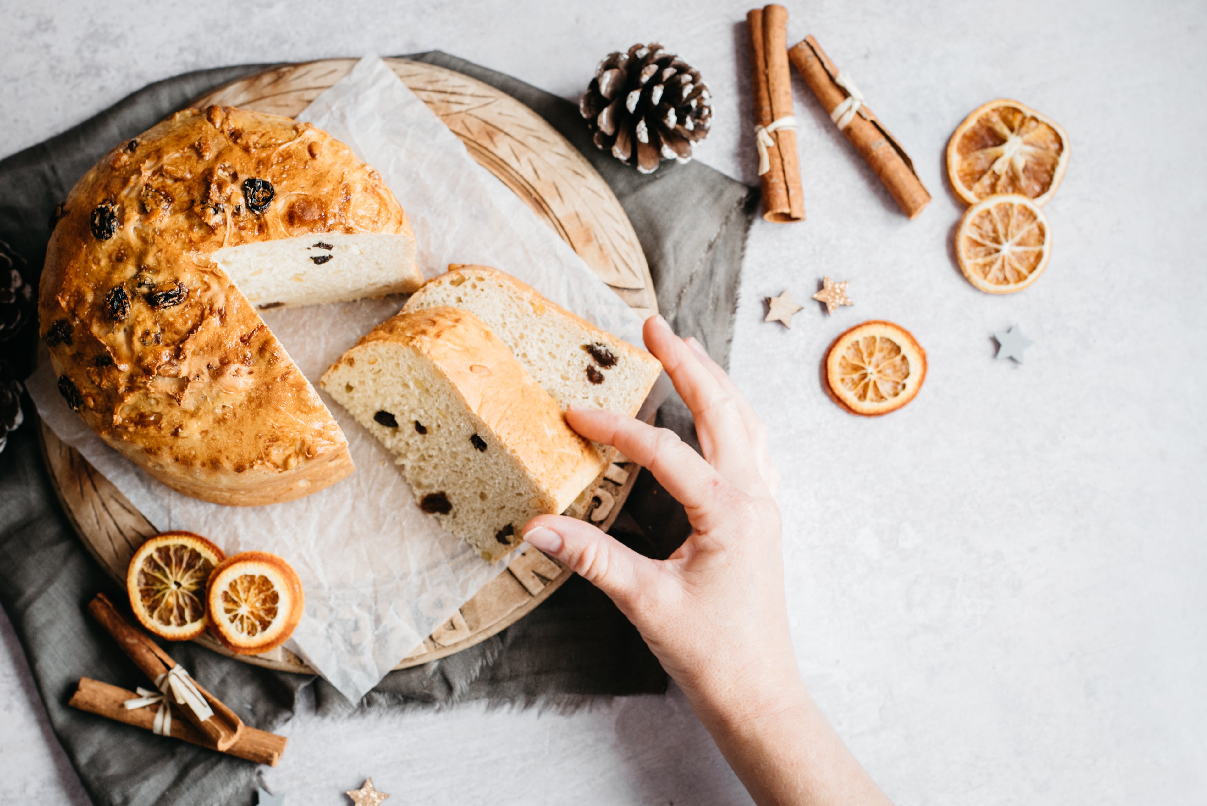 Hand reaching in for a slice of Panettone, made using Allinson's Strong White Flour