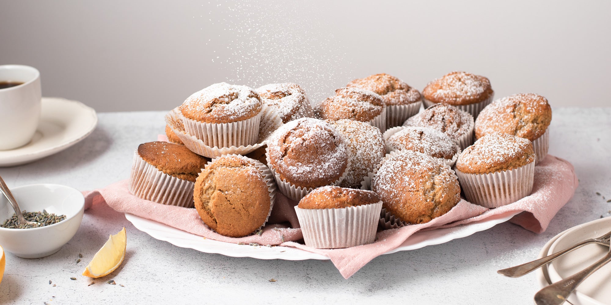 Pile of muffins coated with icing sugar