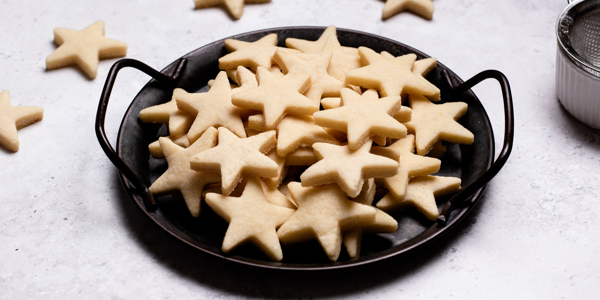 A side on view of star shaped vegan biscuits in a bowl