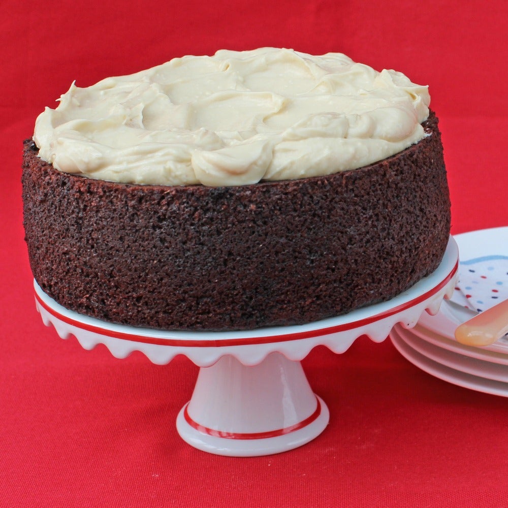 Guinness cake with cream cheese frosting on a cake stand