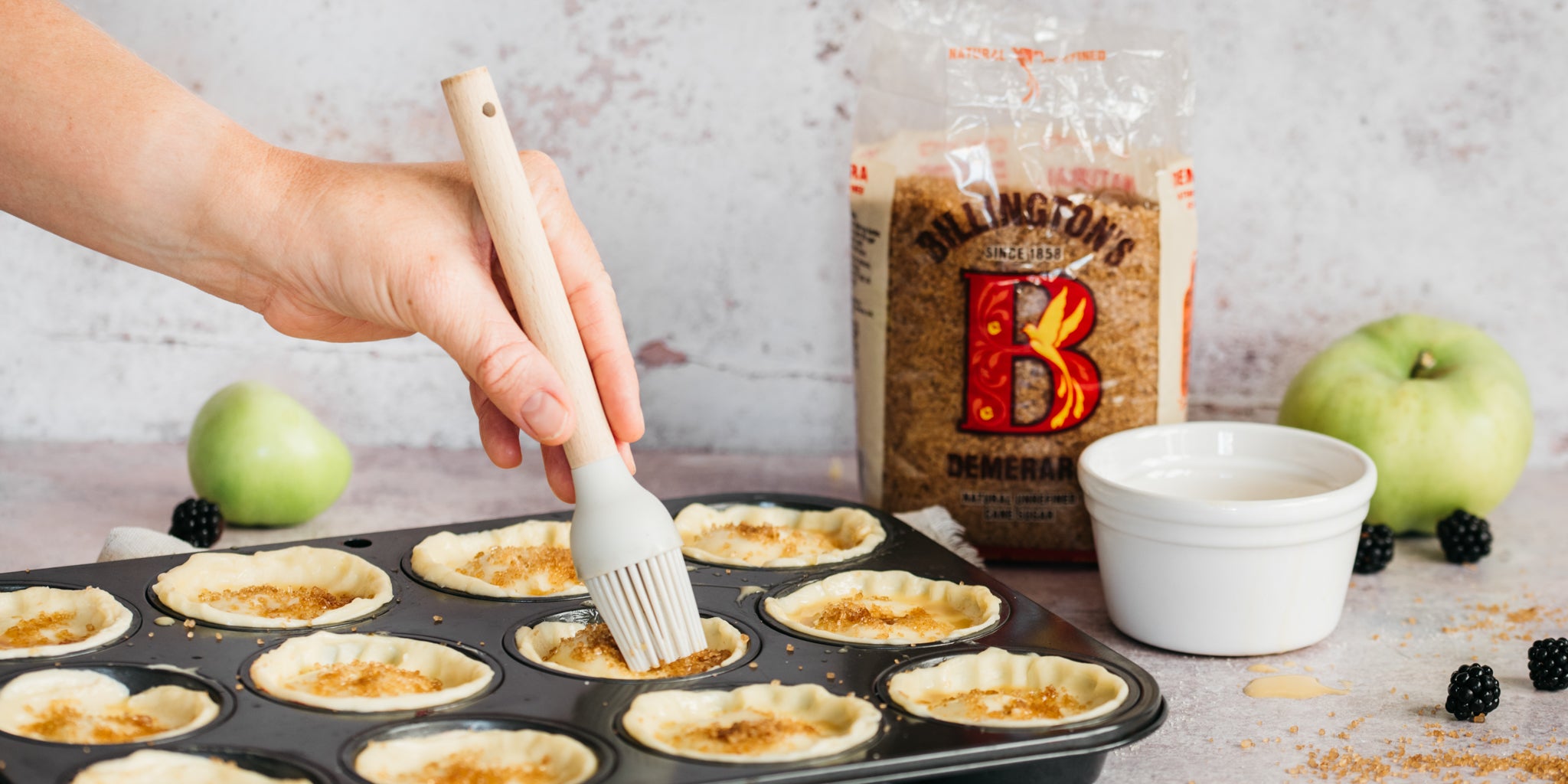 Hand brush the top of pies in baking tray