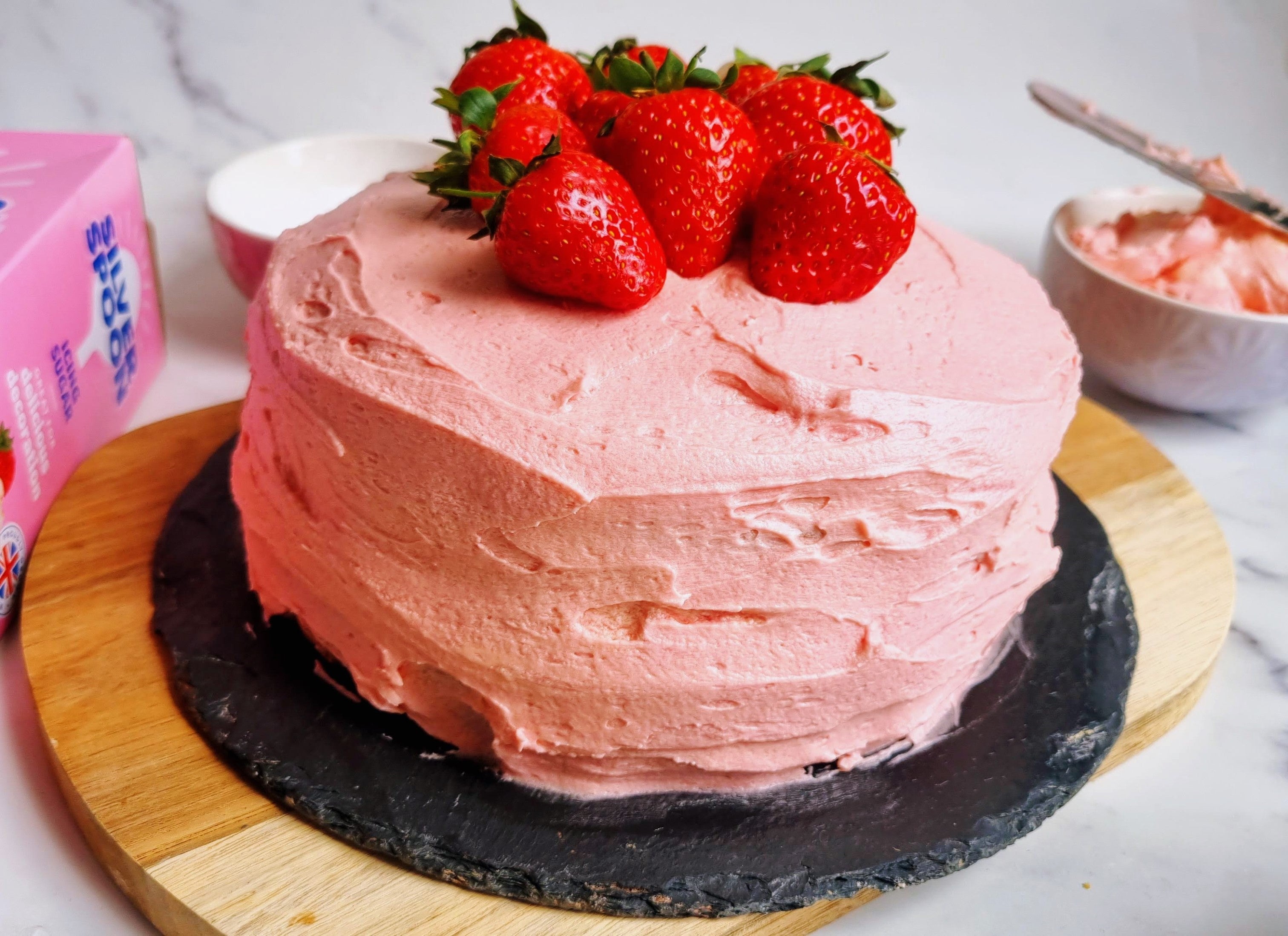 Close-up of a pink strawberry cake icing with pink buttercream 