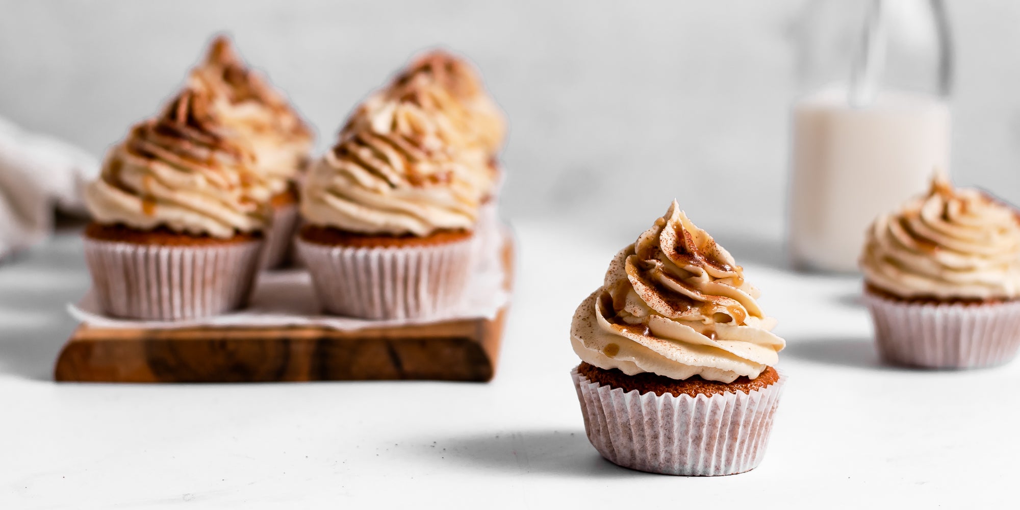 Single Gingerbread Cinnamon Cupcake decorated with buttercream drizzled with caramel sauce