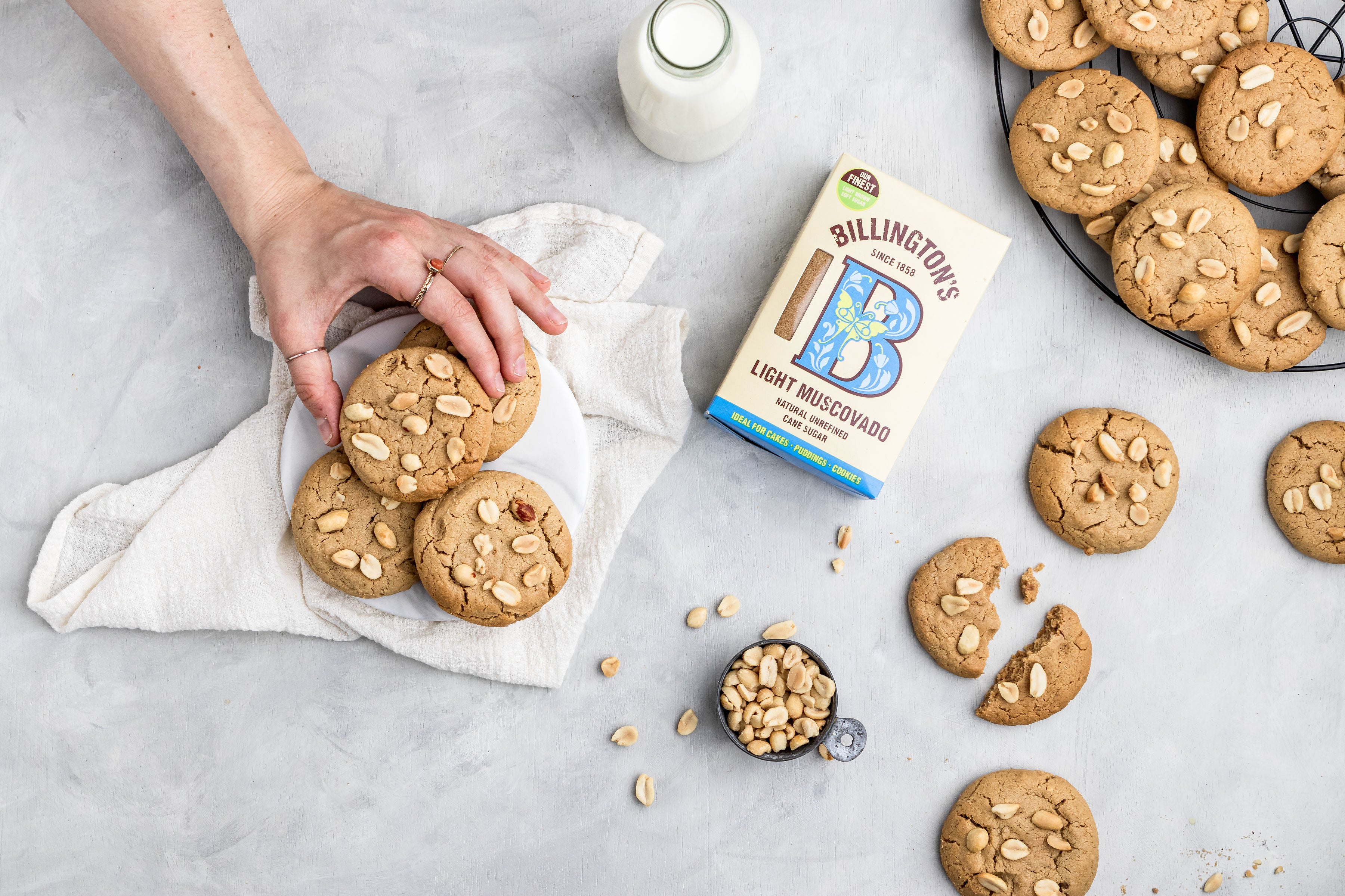 peanut butter cookies with a person grabbing one cookie