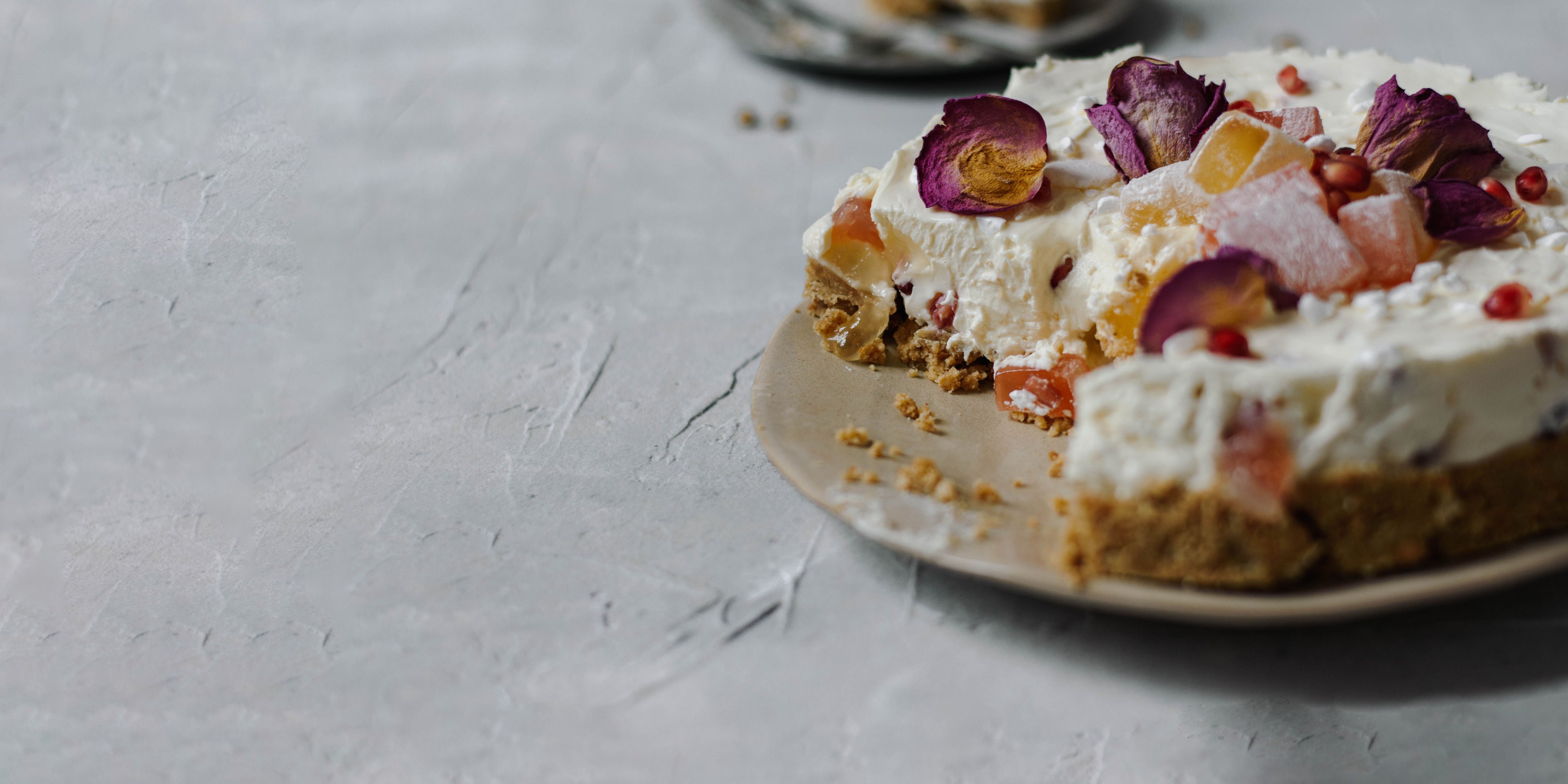 Close up of cheesecake on white plate with slice removed