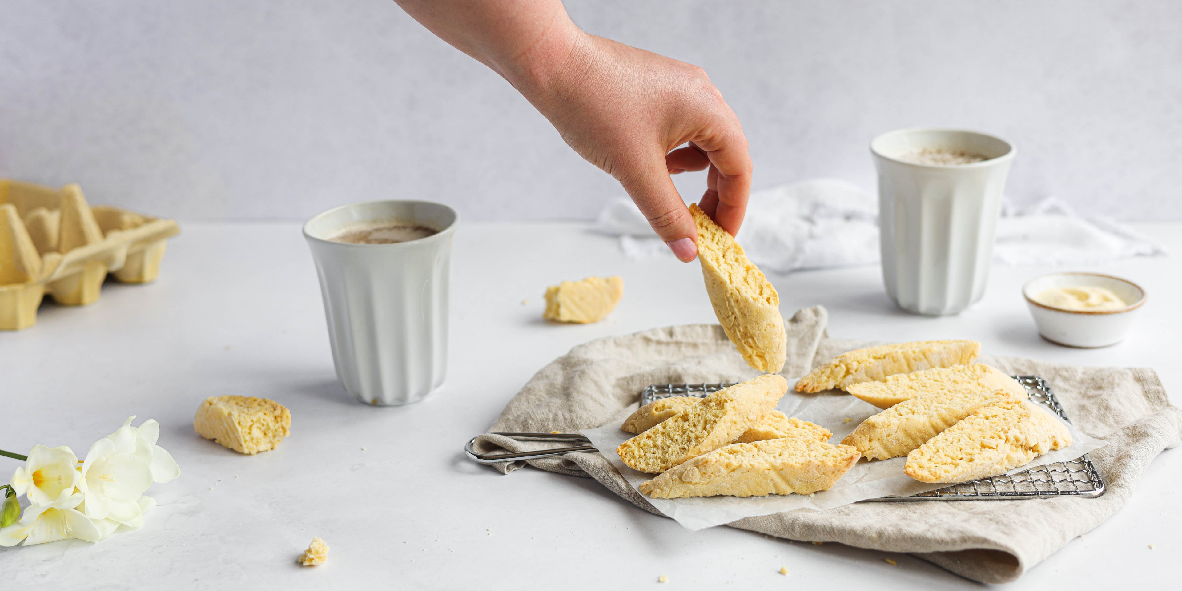 Vanilla biscotti, flowers and two cups of coffee