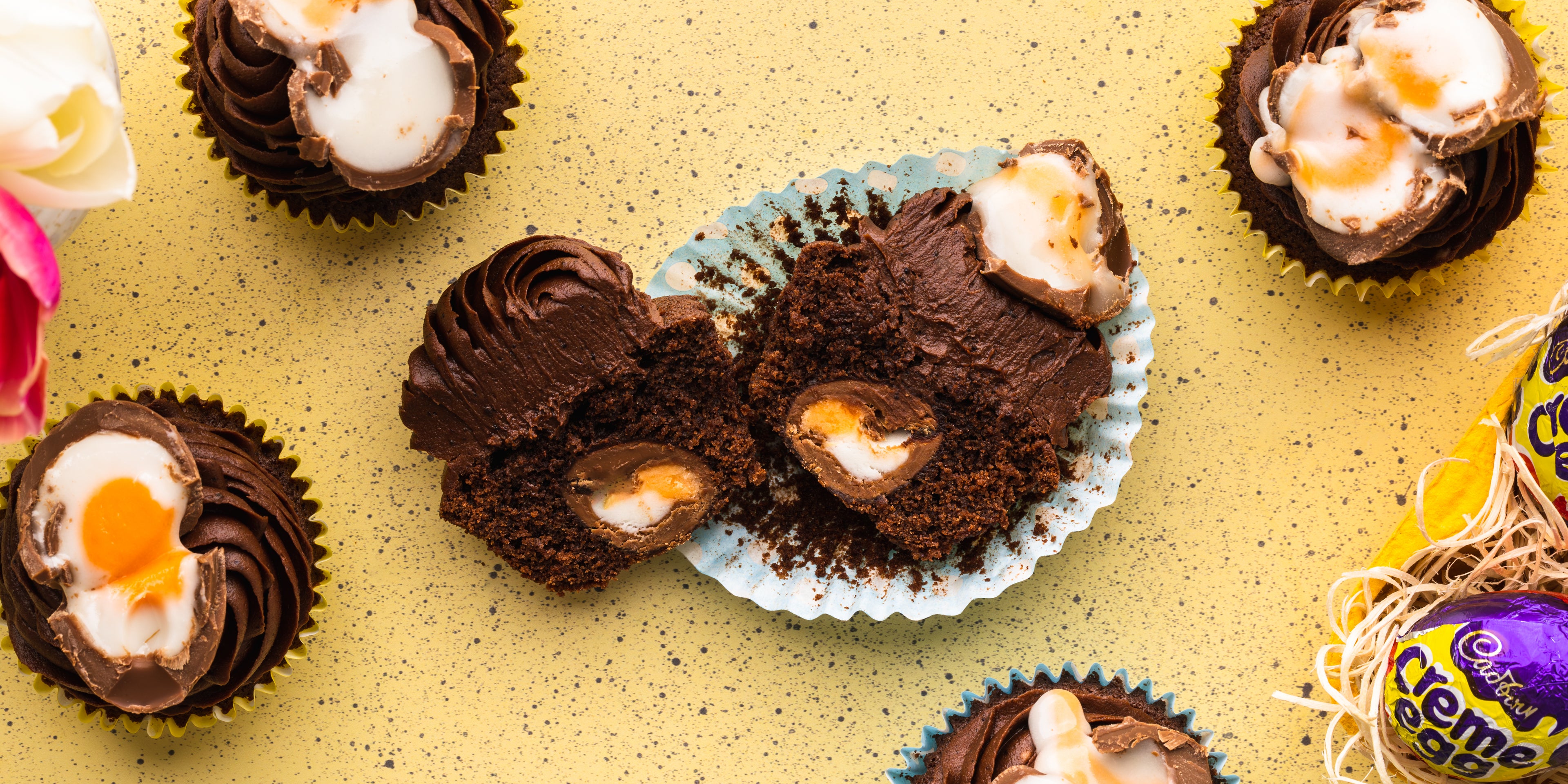 Chocolate cupcake pulled apart with a creme egg on top