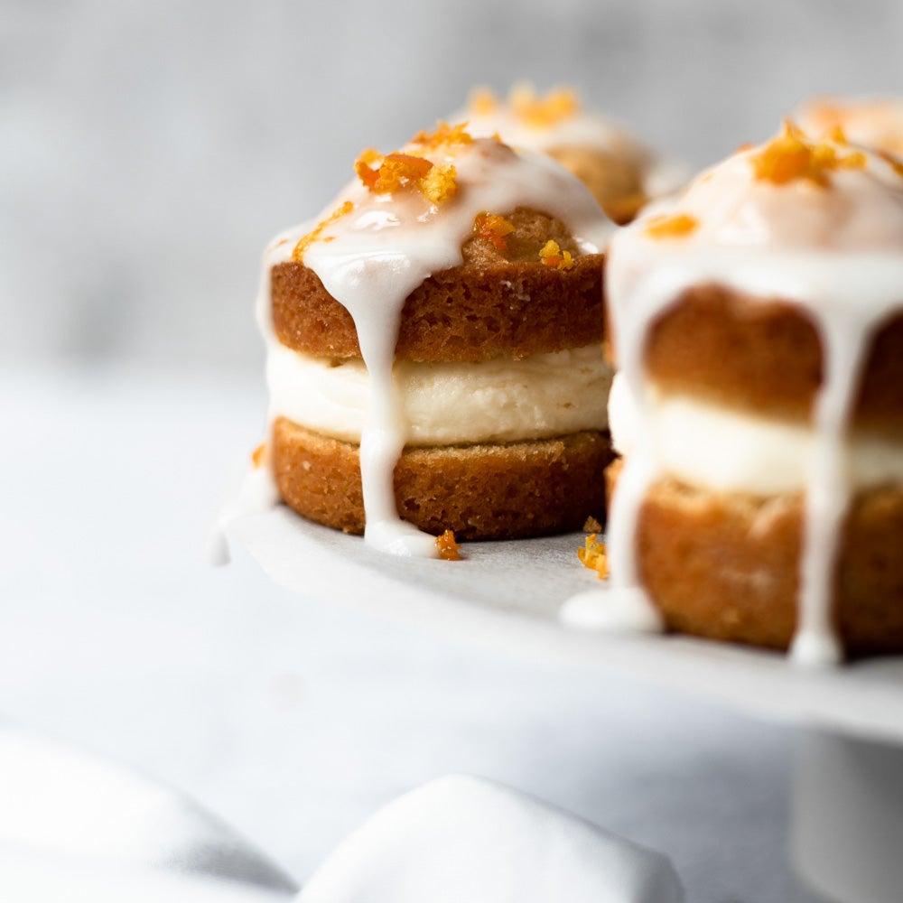 mini orange sponge cakes with glace icing on top 