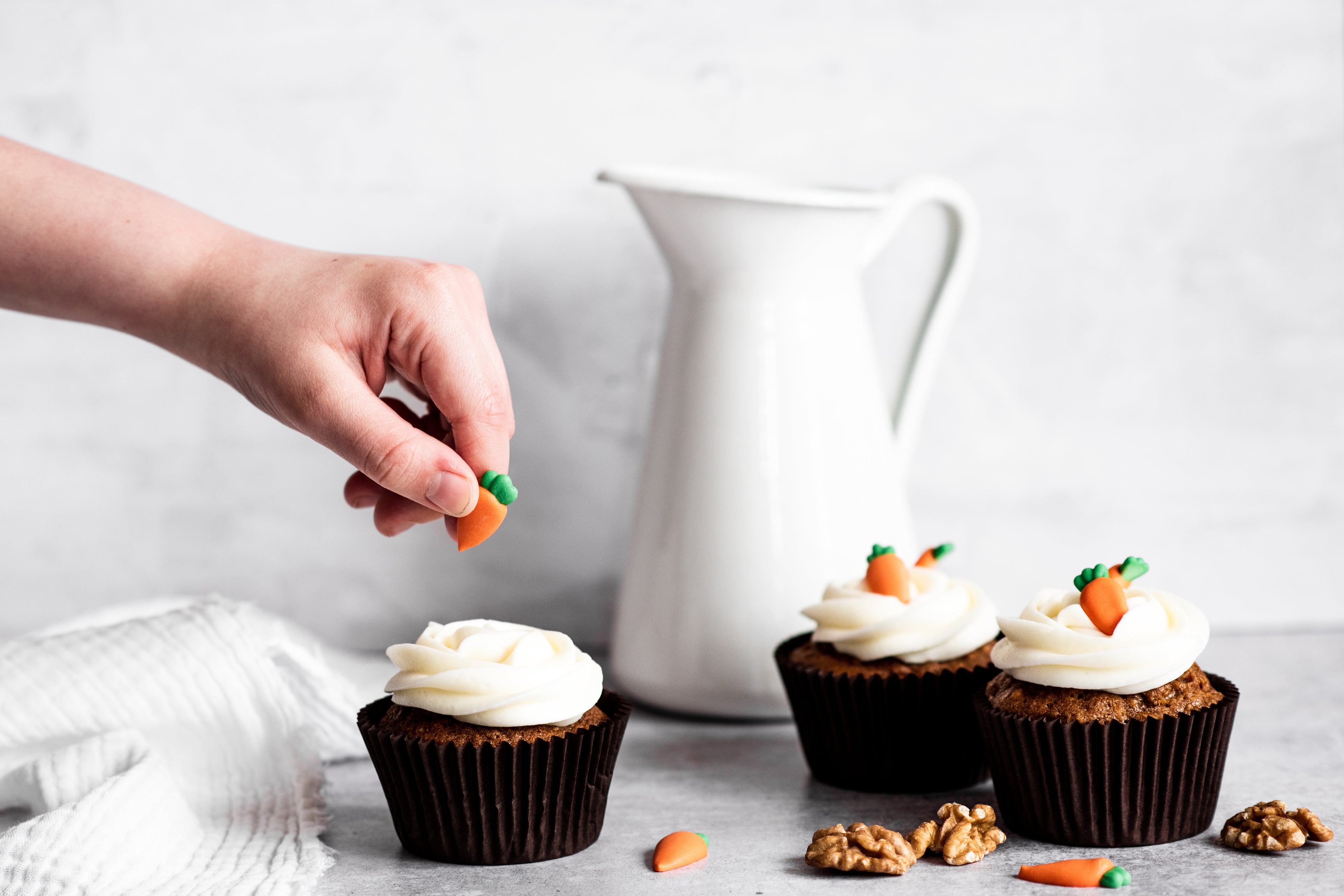 Carrot cake cupcakes with cream cheese icing and carrot decorations