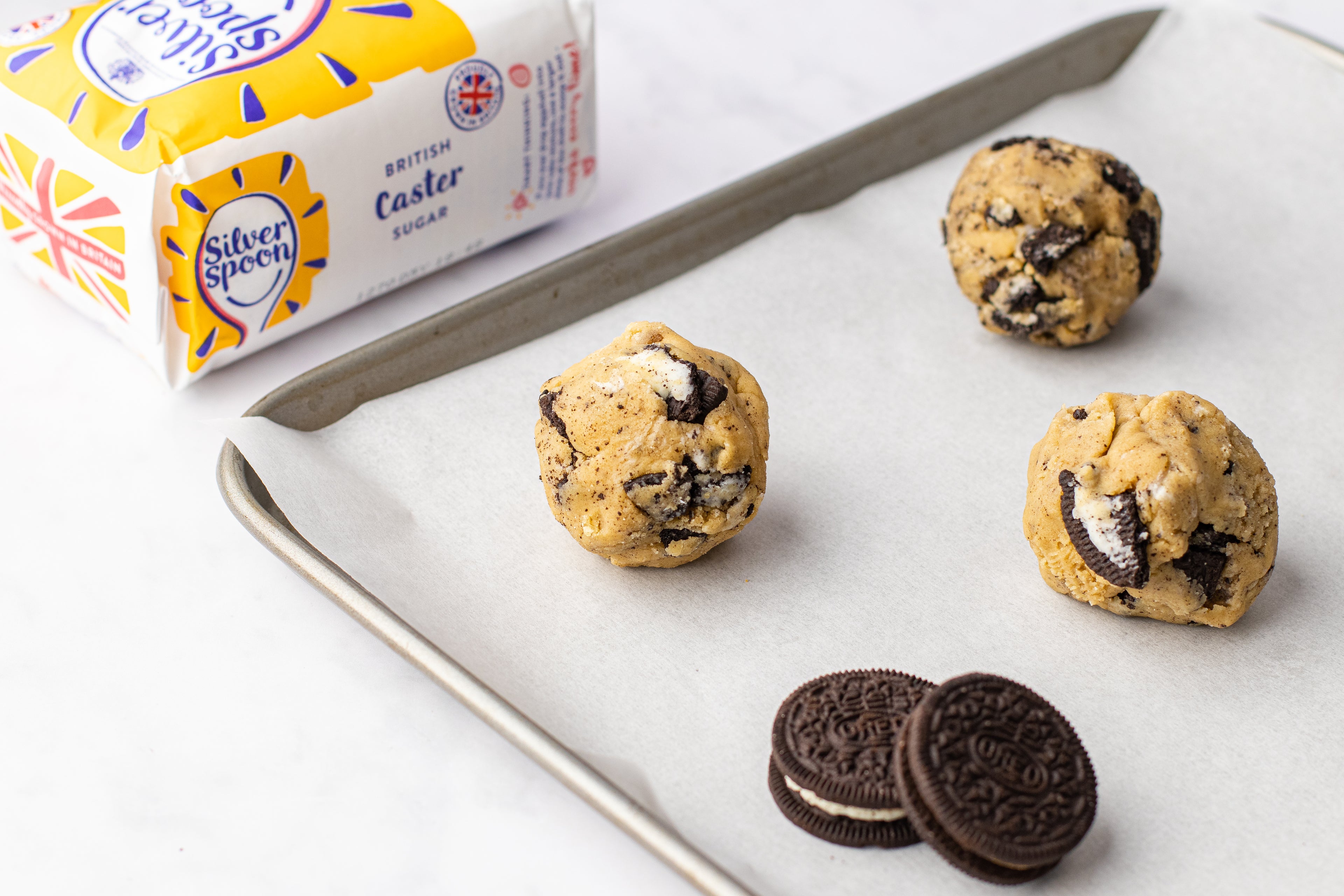 Balls of cookie dough on a baking tray
