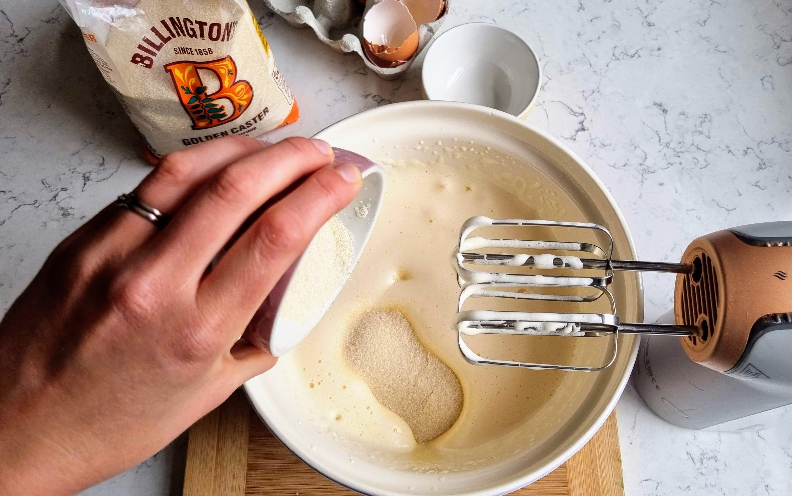 Mixing together the ingredients for white chocolate brownies in a mixing bowl