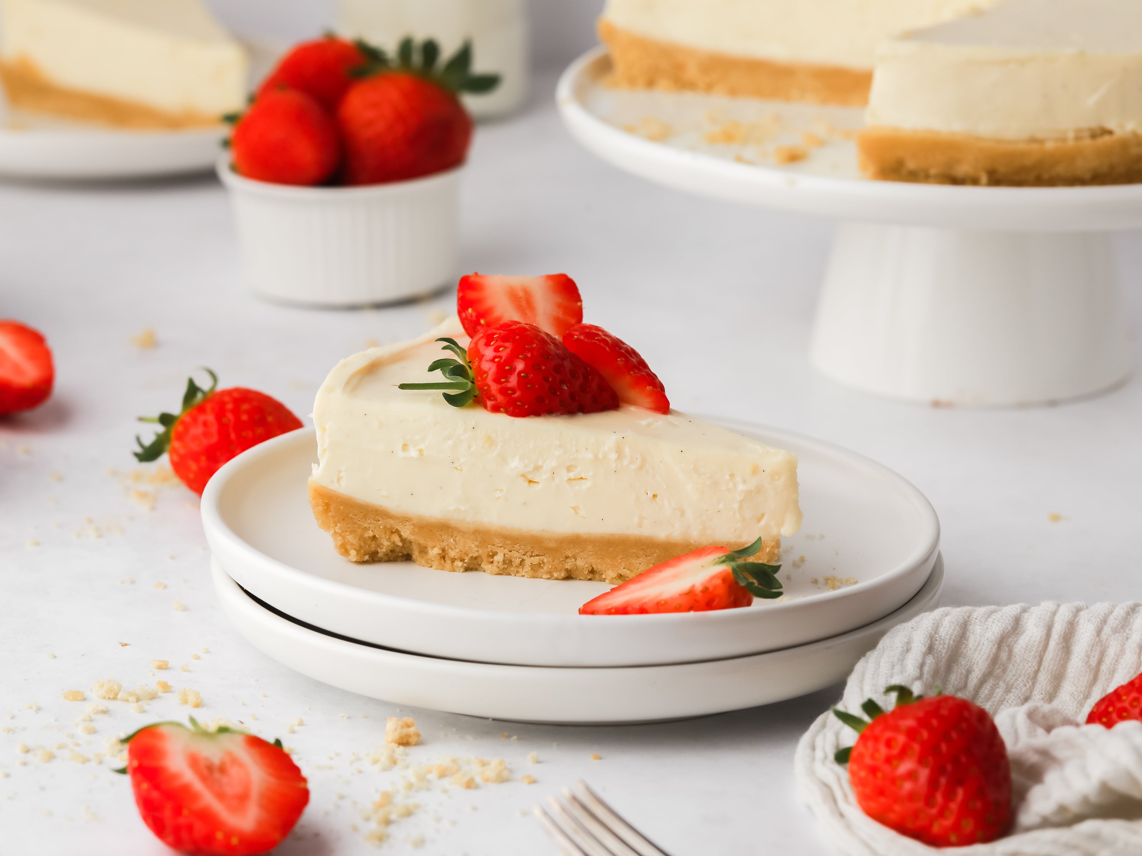 Slice of vanilla cheesecake with strawberries on top