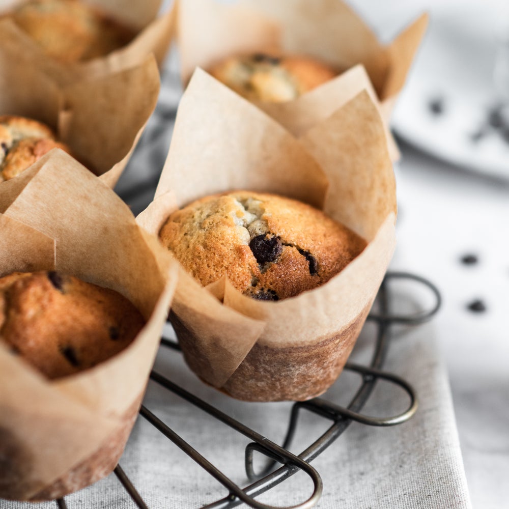 Banana and chocolate chip muffins wrapped in parchment cases