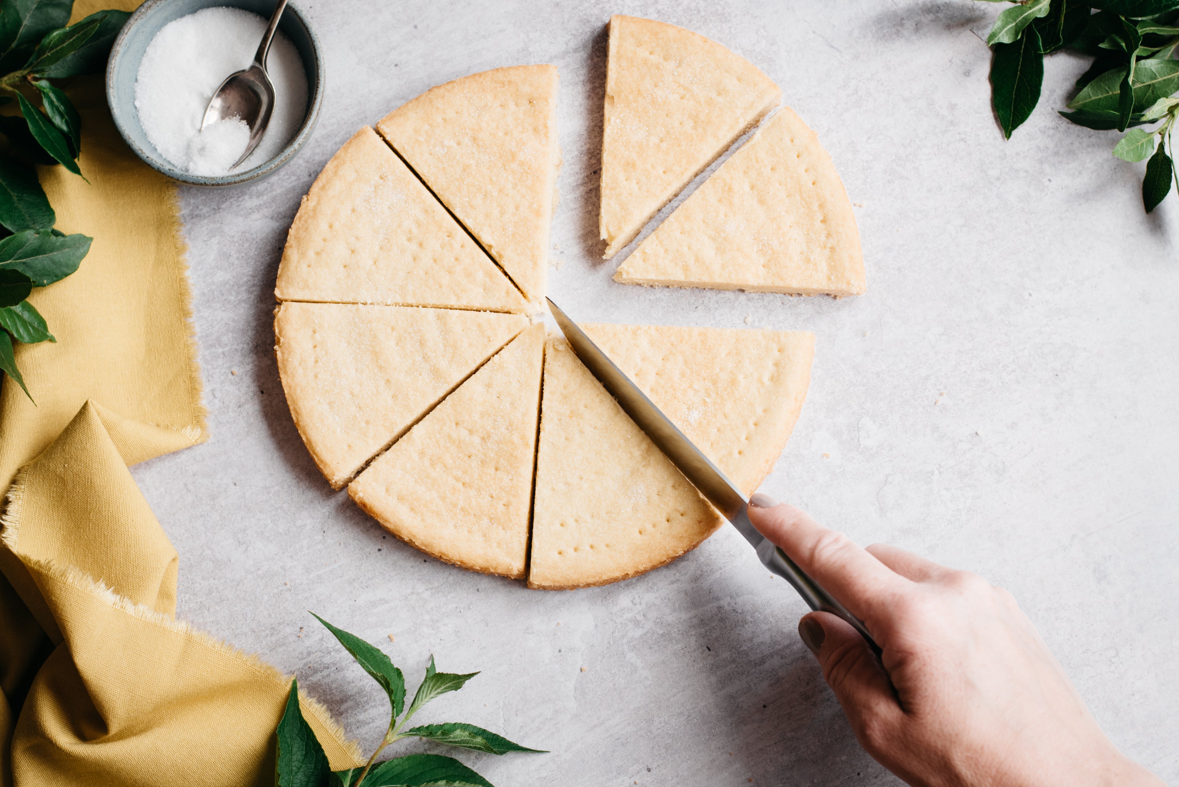 Top down view of a knife slicing through some healthy shortbread
