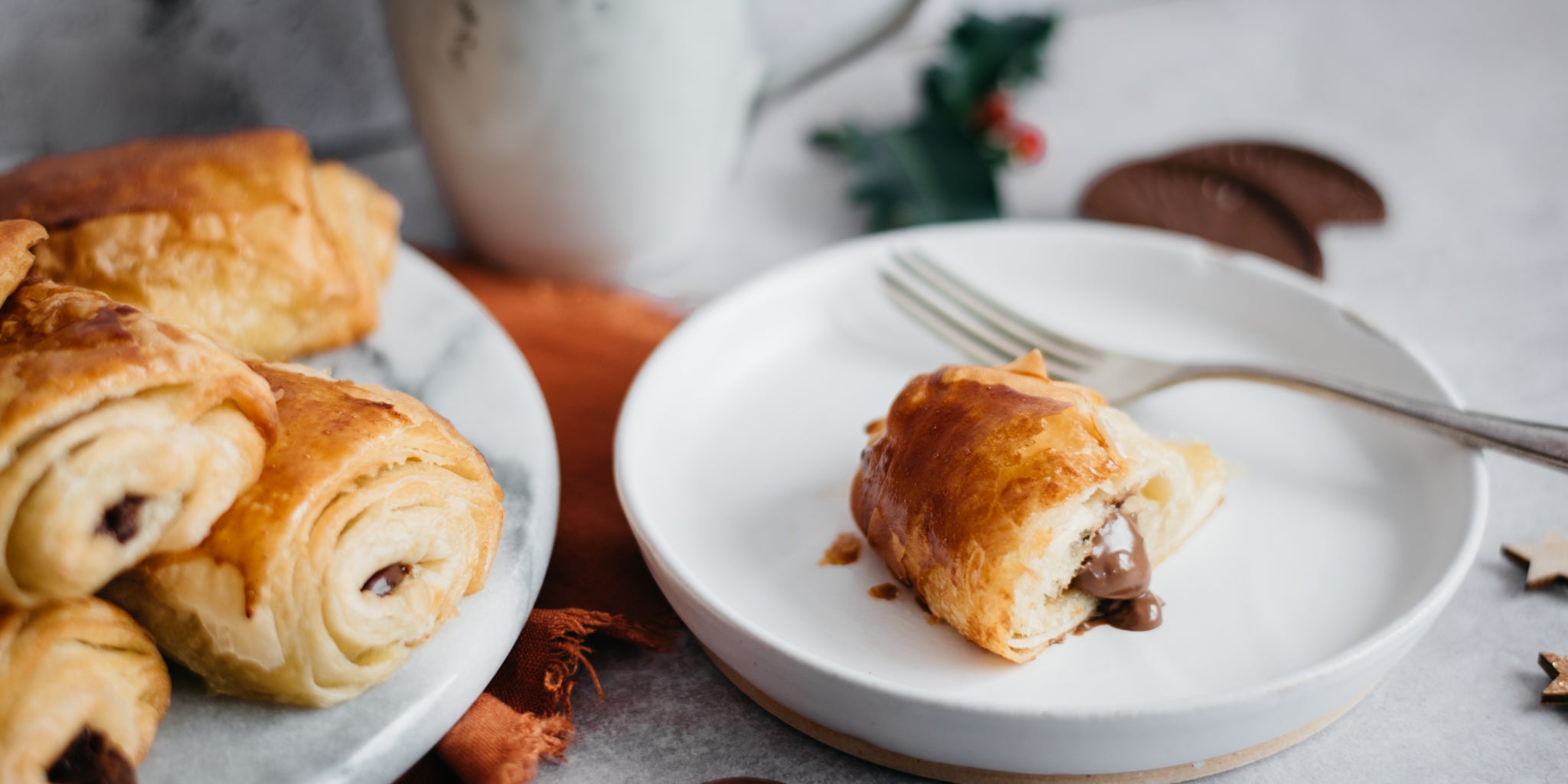 Terrys chocolate orange oozing out of pain au chocolat next to a plate of pain au chocolats