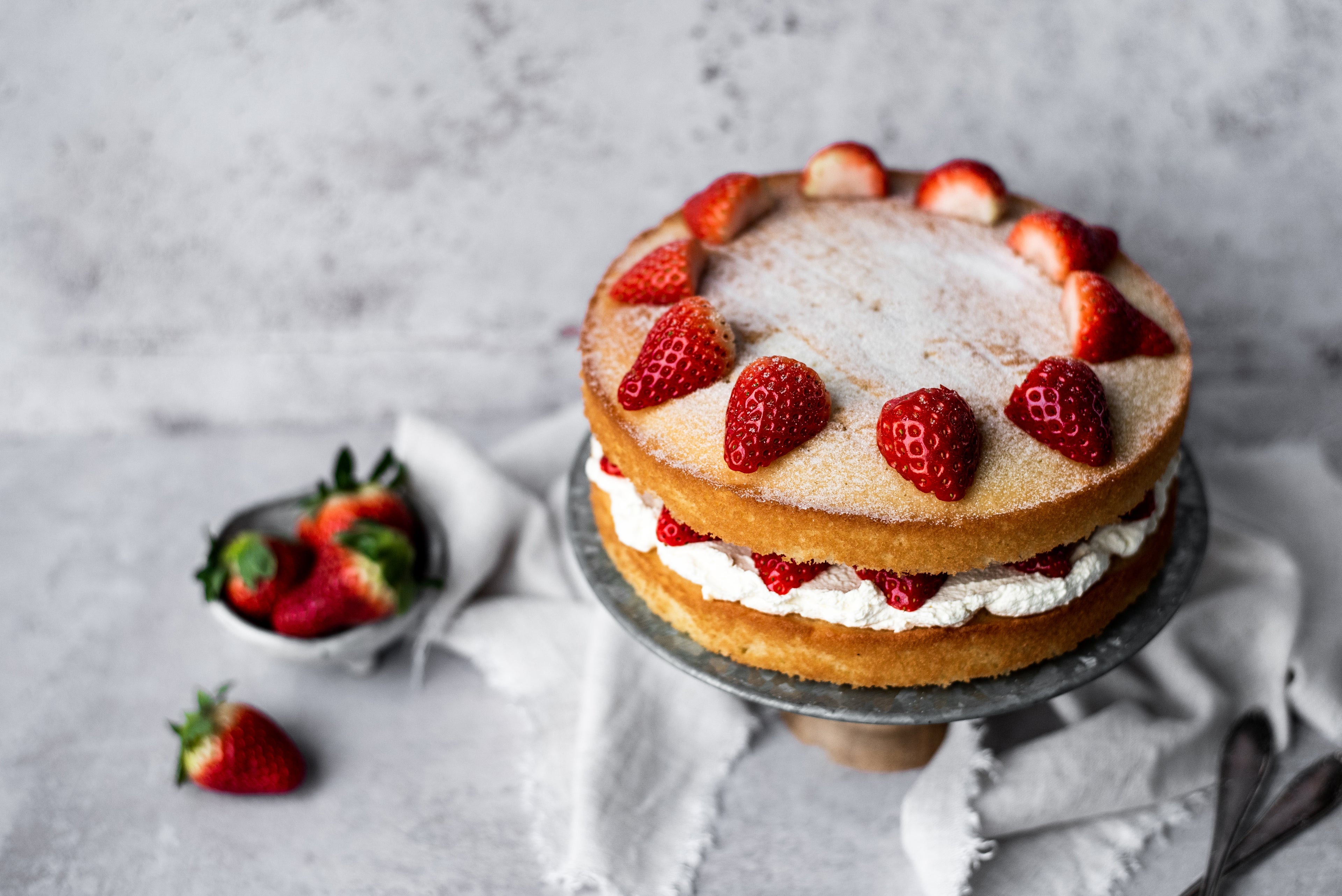 strawberries on top of a sponge cake