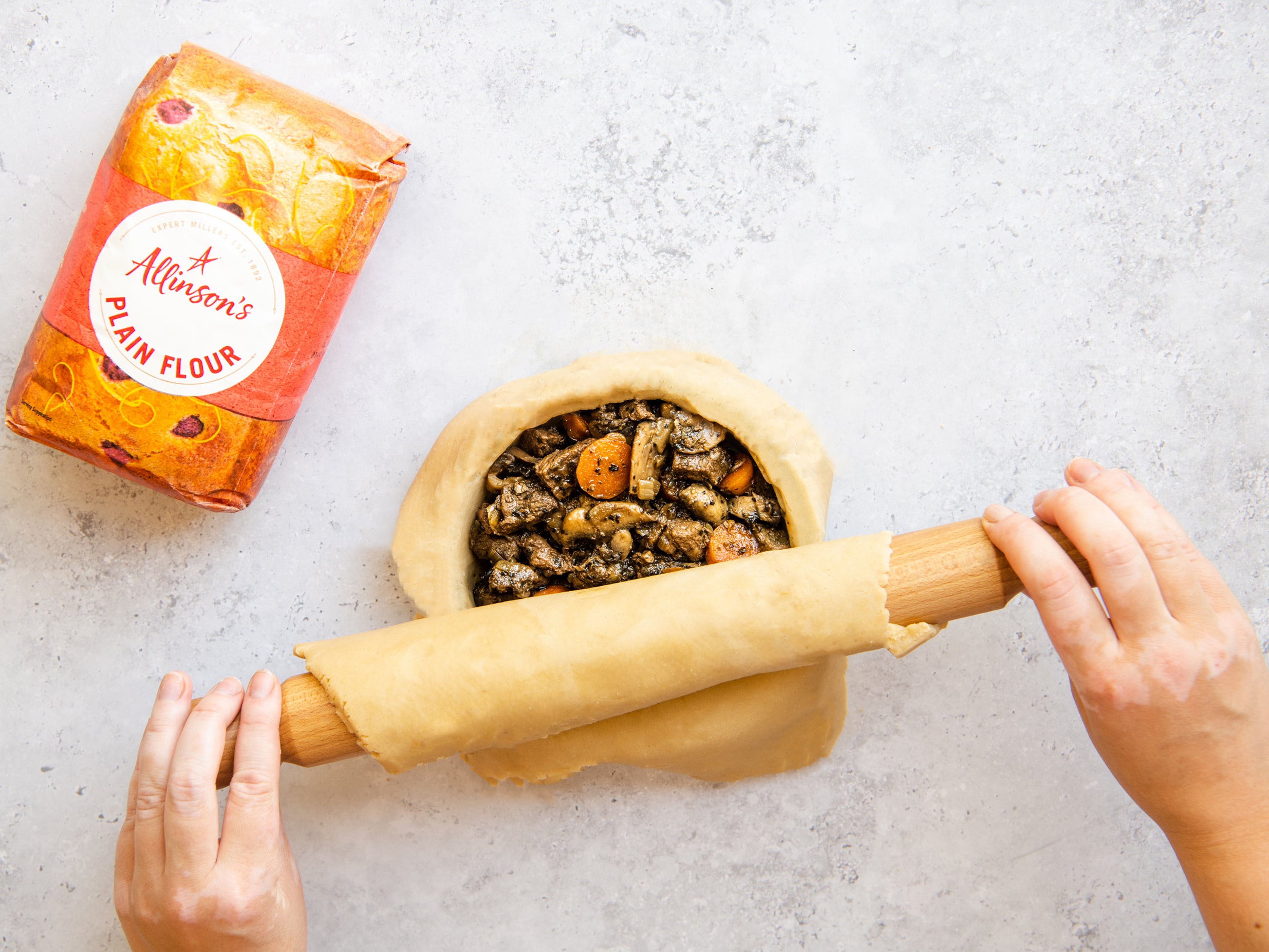 Covering the top of a steak pie with a layer of pastry