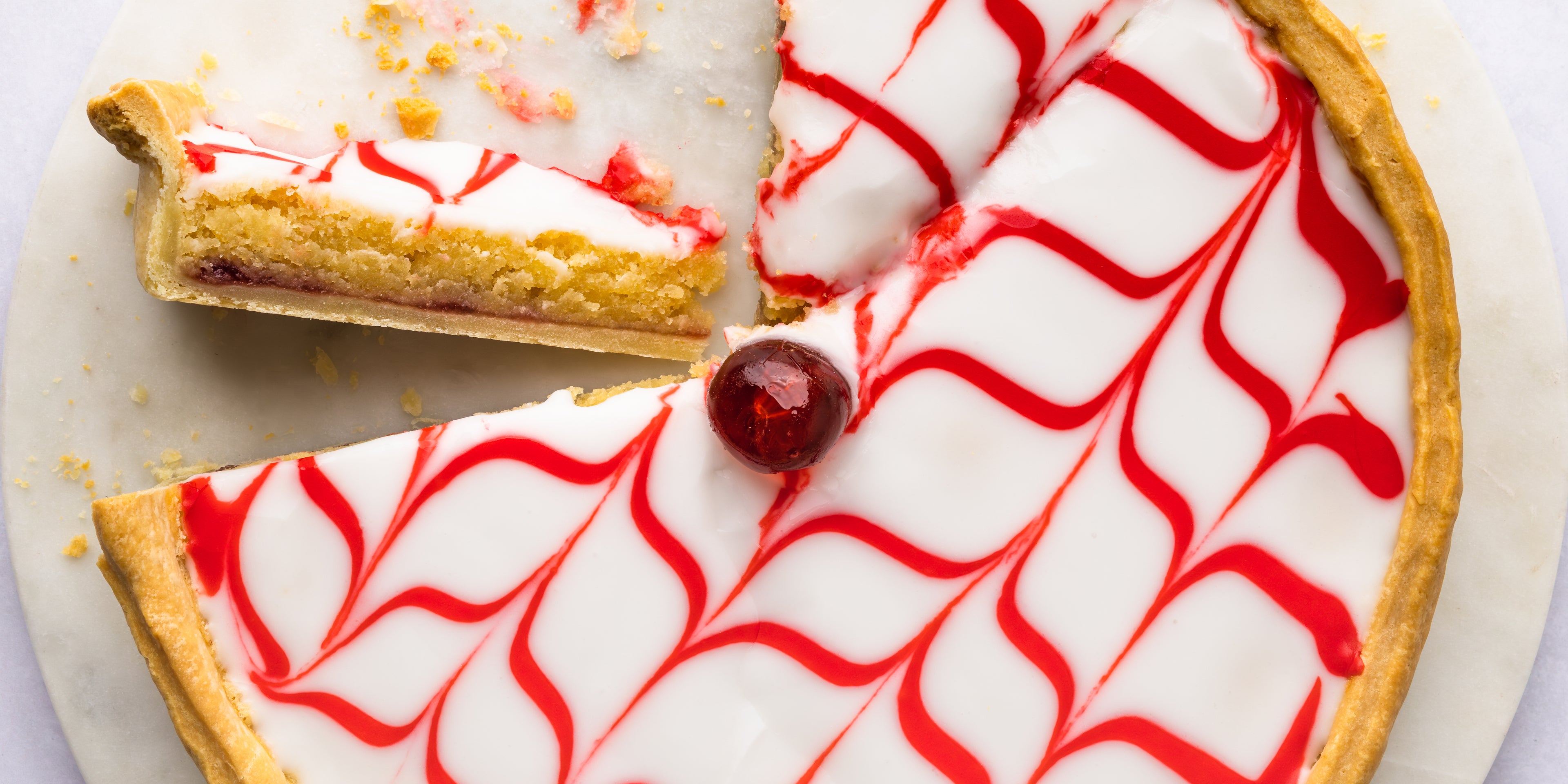 Bakewell tart with slice cut out and turned on its side