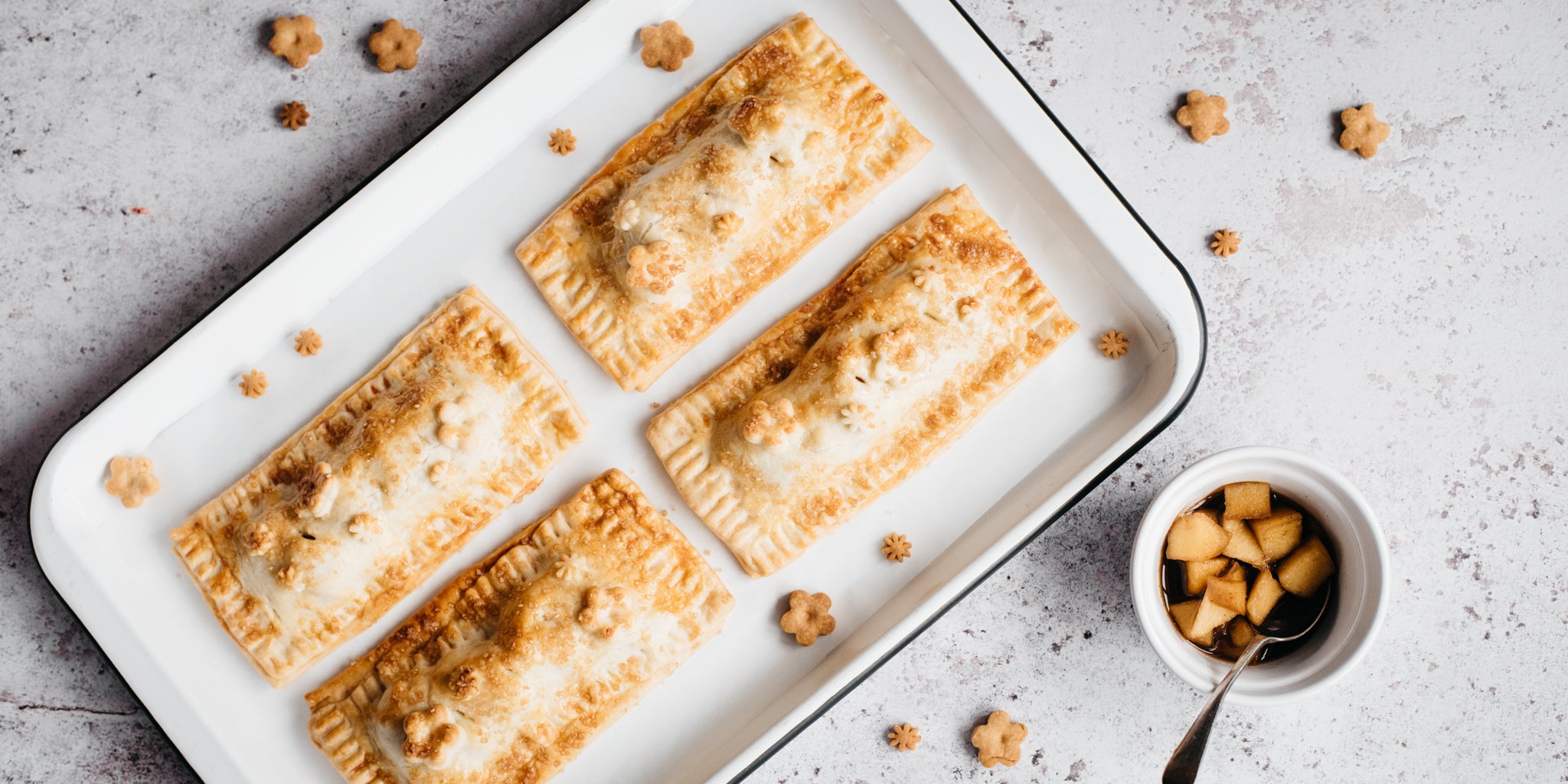 Baked apple pie pockets on a baking tray