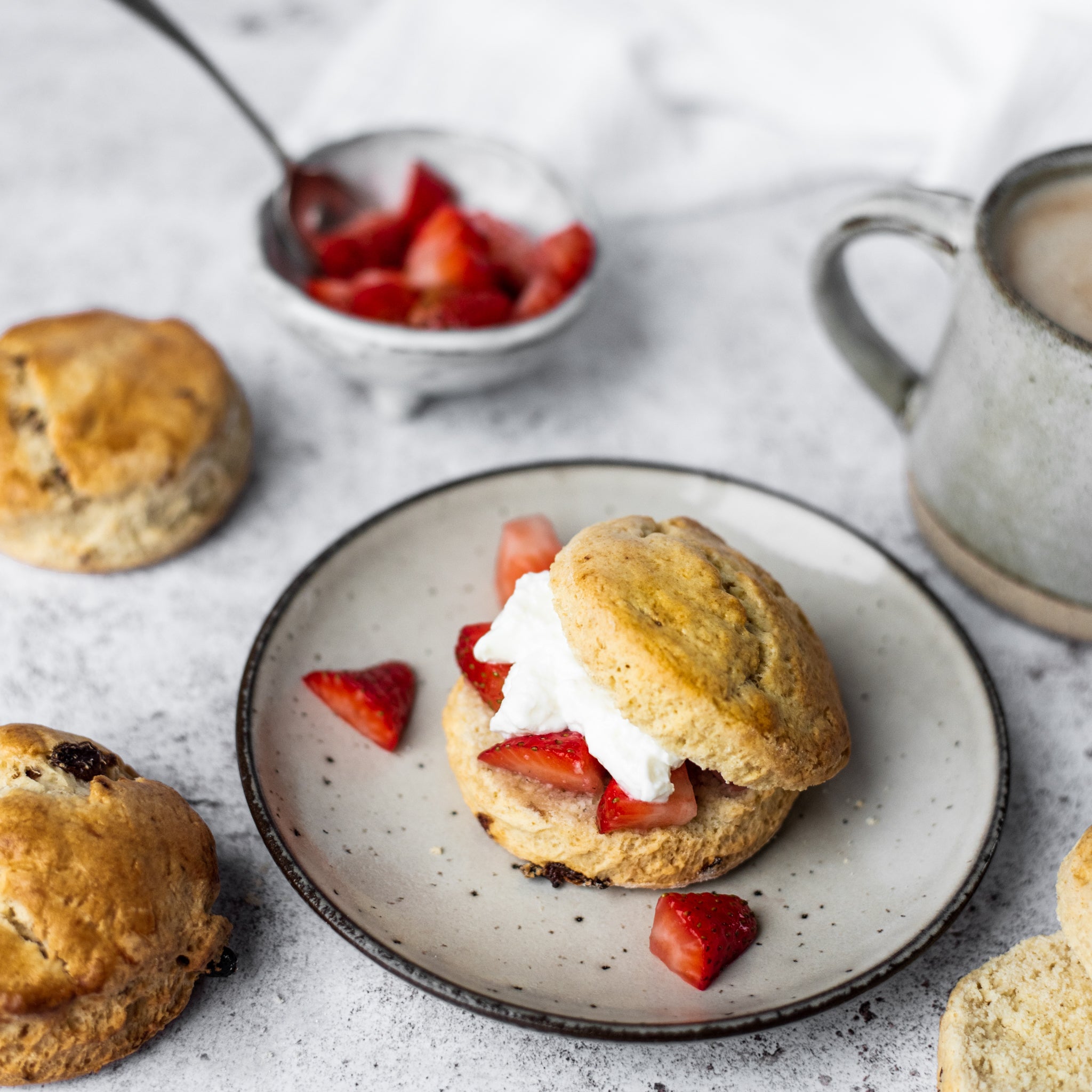 scone with strawberries and cream on a plate