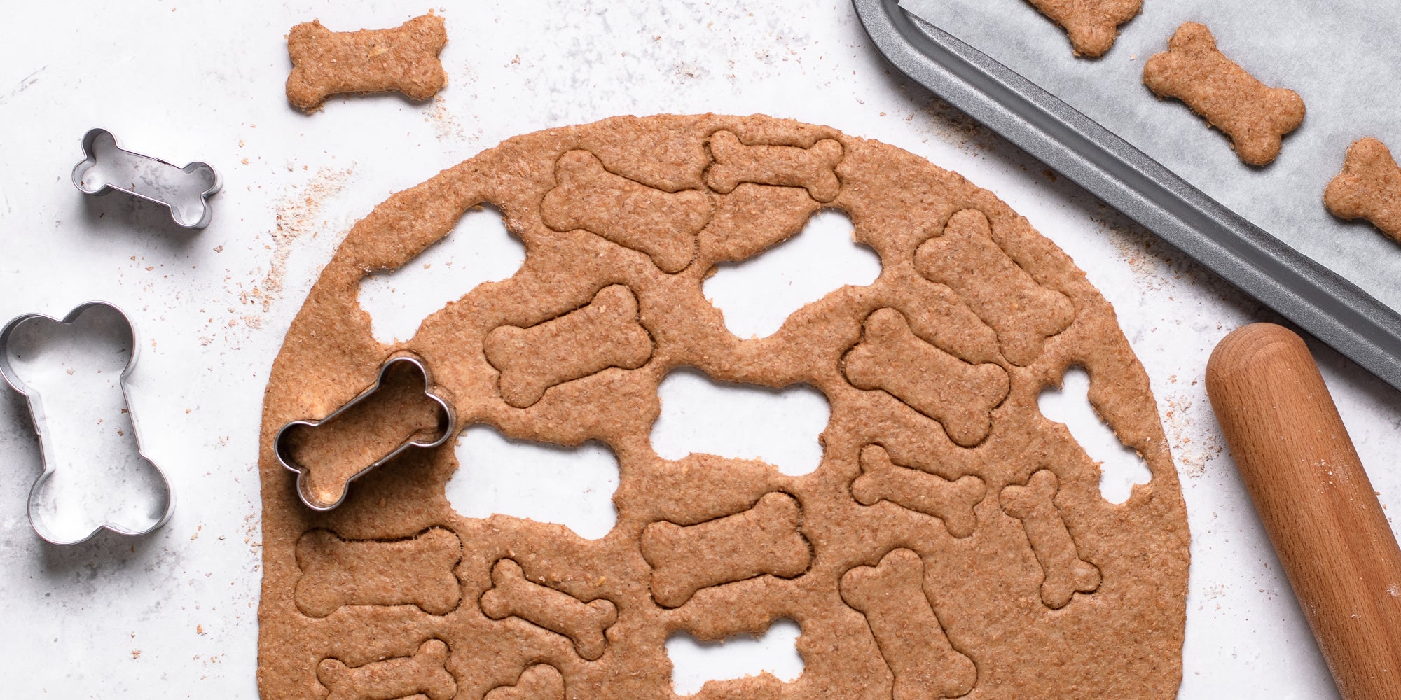 Dog Biscuit dough rolled out with cut out bone shapes