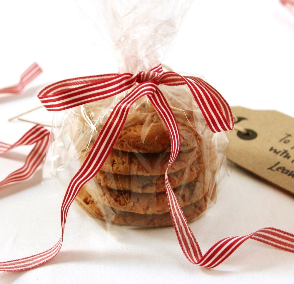 Orange Christmas cookies, wrapped in plastic with a ribbon