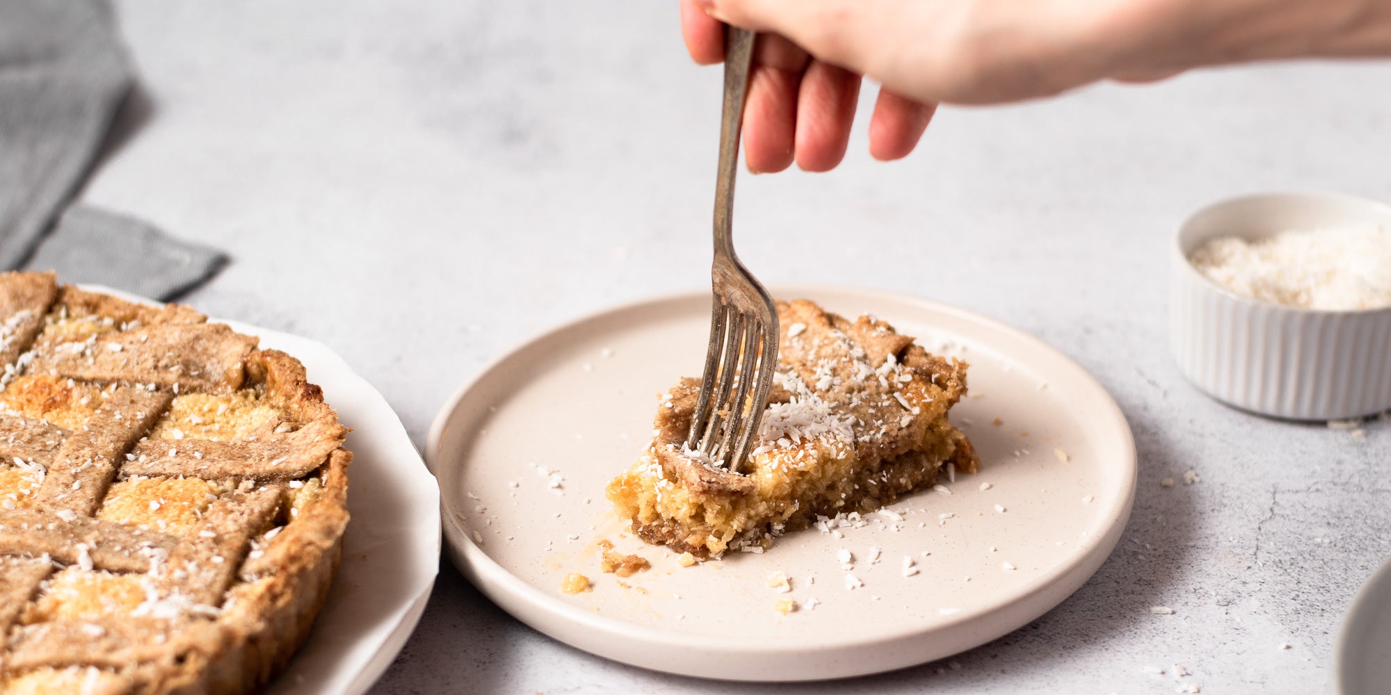 fork in a slice of coconut tart