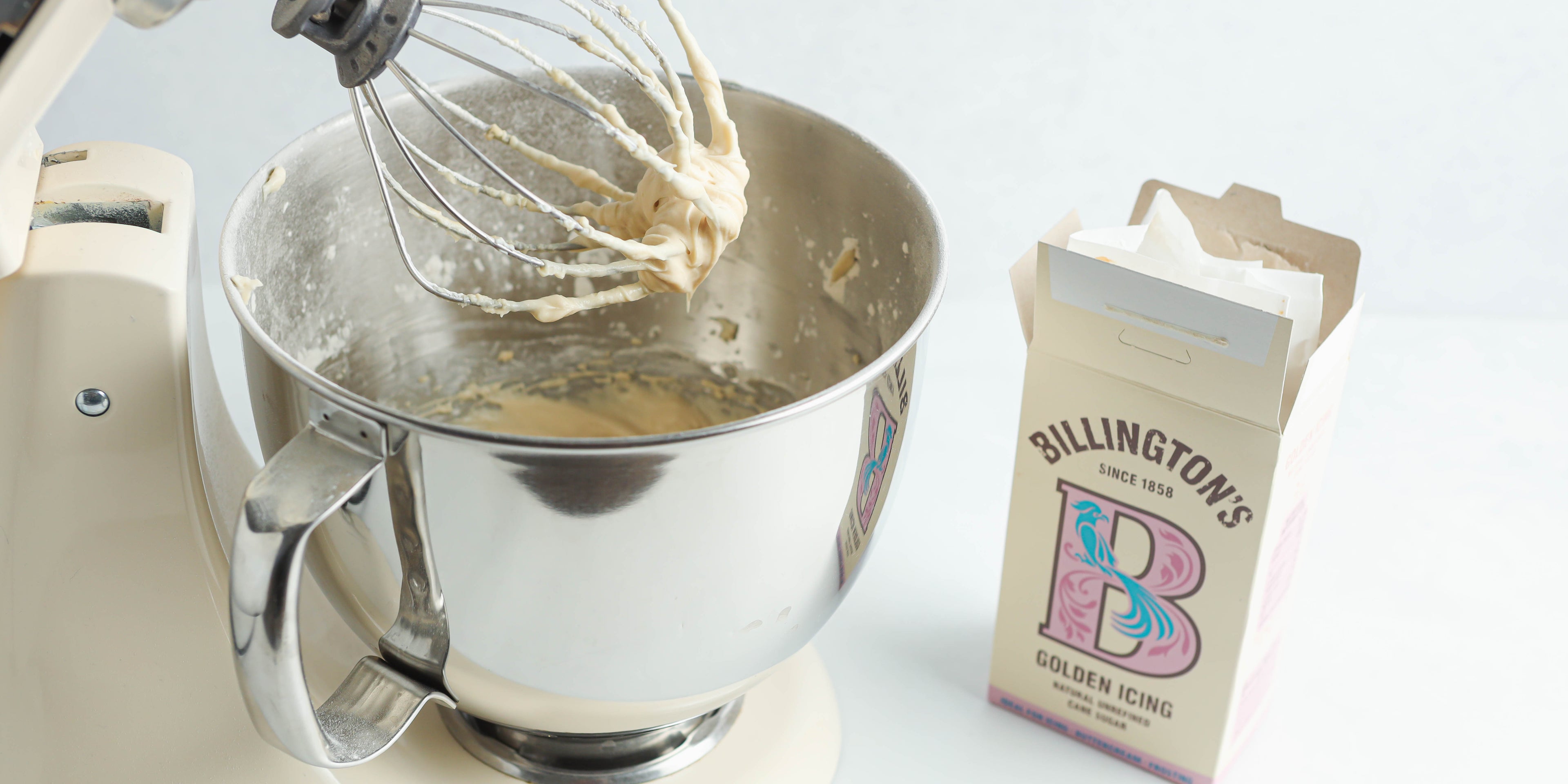 Close up of cream cheese frosting for the Classic Carrot Cake being mixed with Billington's Golden Icing Sugar