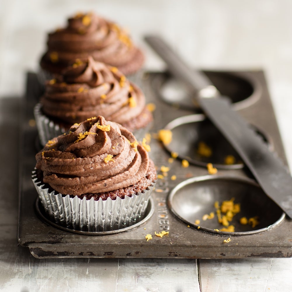 Chocolate orange cupcakes topped with rich chocolate icing and fresh orange zest