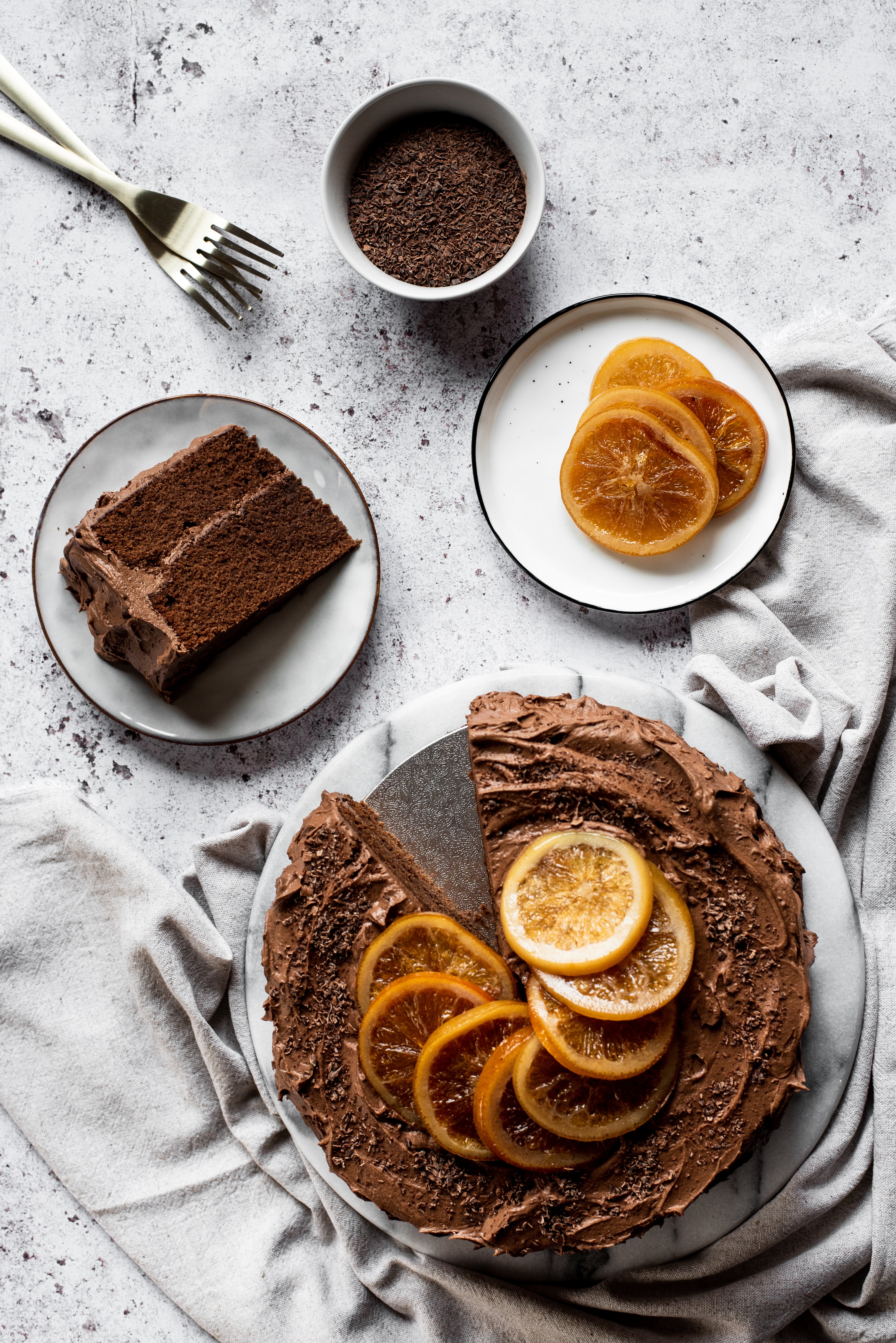 birds eye view of chocolate cake with orange slices on top with a slice taken out