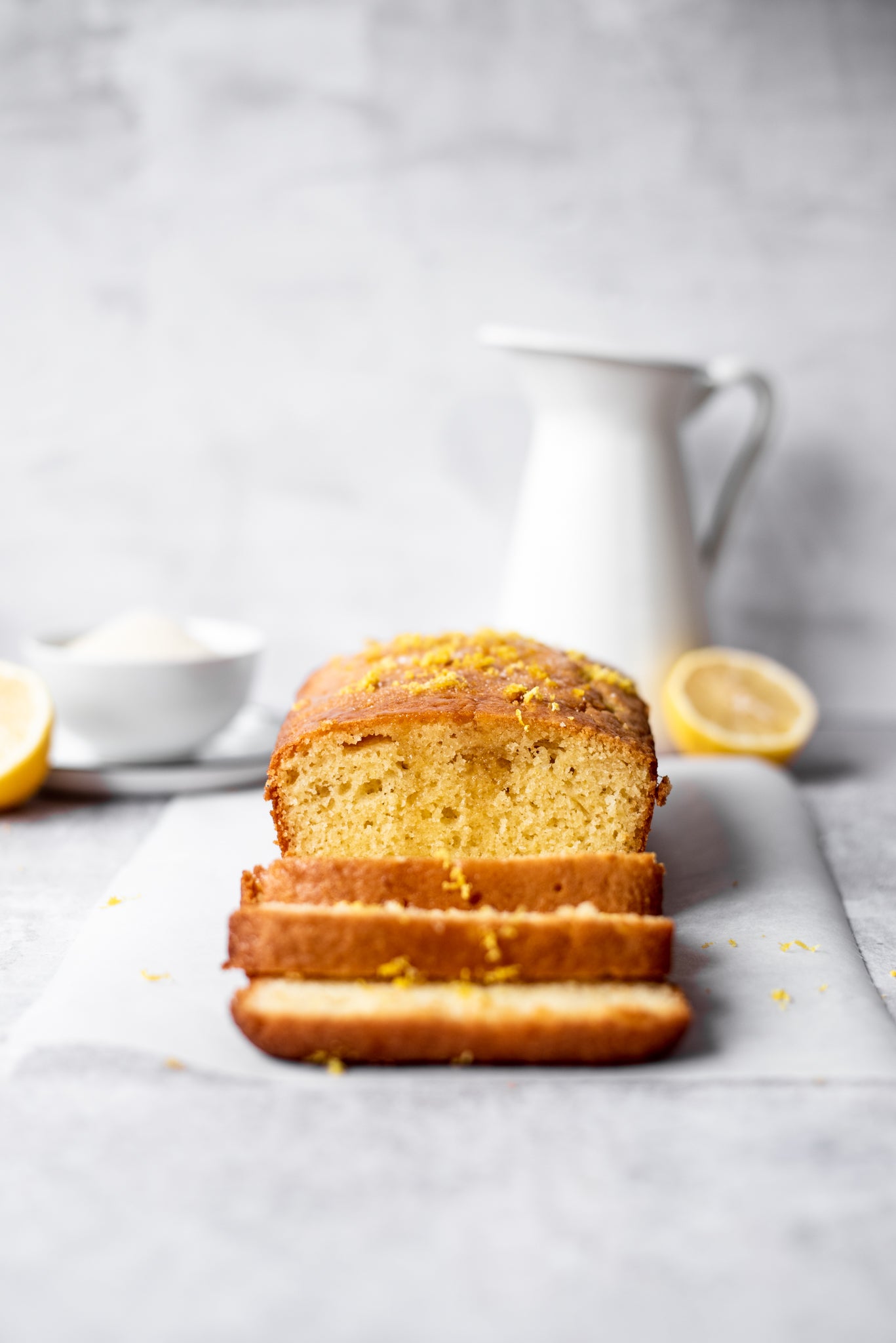 Slices of lemon drizzle cake topped with a sprinkle of lemon zest