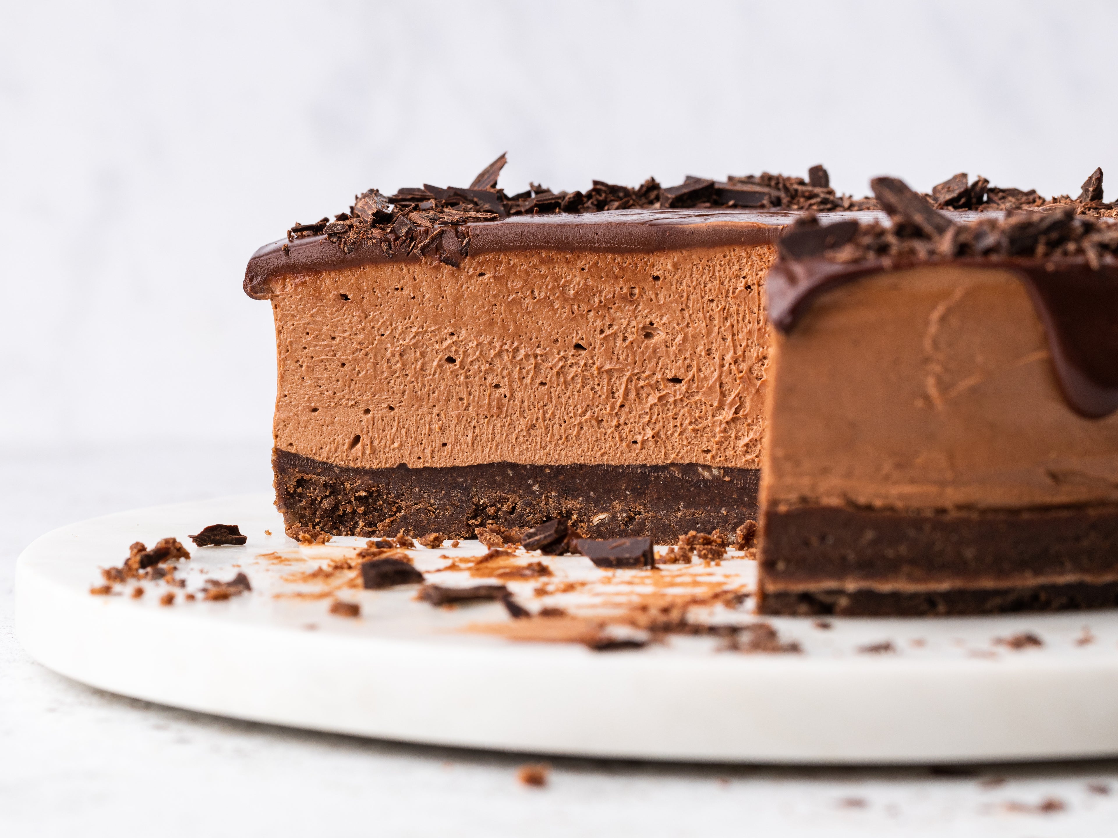 Close up shot of a chocolate cheesecake with a slice removed